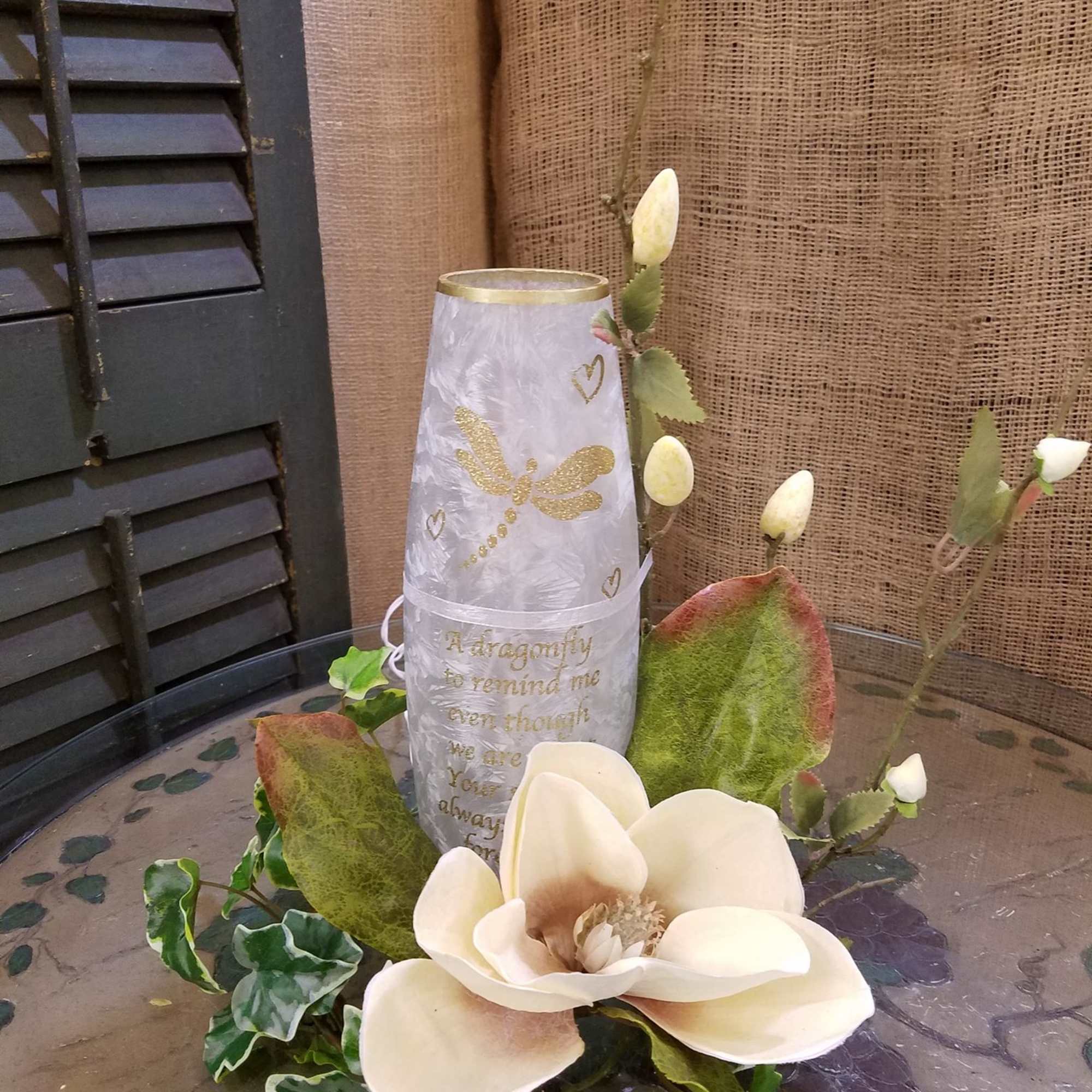 White magnolia flower arrangement with a decorative candle holder