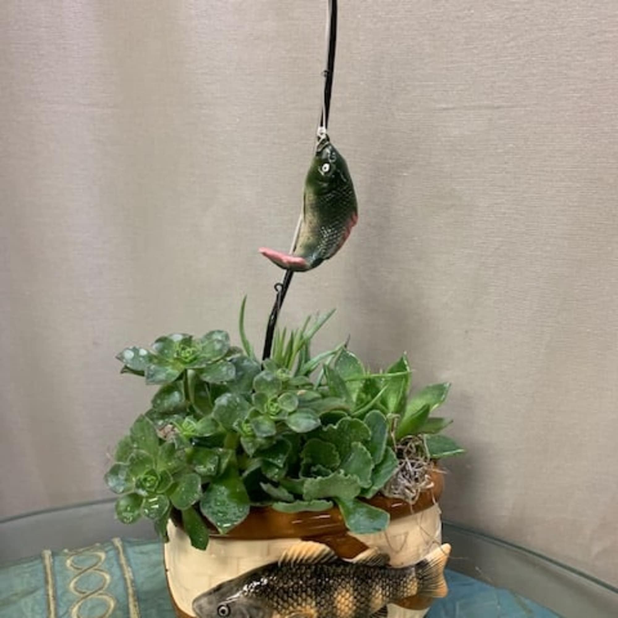 Succulent planter in a ceramic pot with decorative fish accents