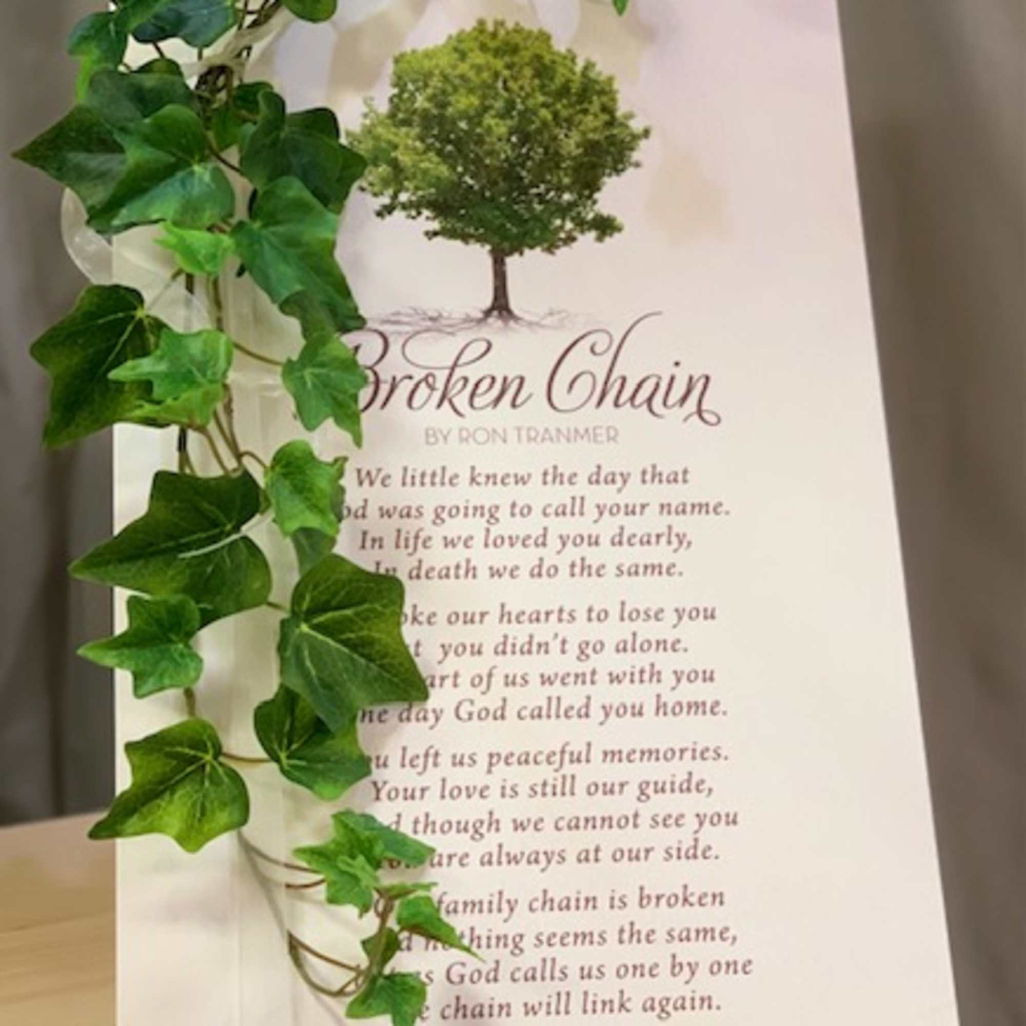 Memorial card with ivy draped over the left side