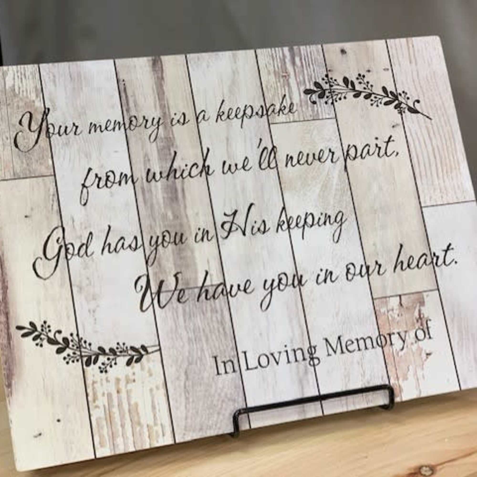 Decorative memorial sign with a sympathy quote on a wood-look background