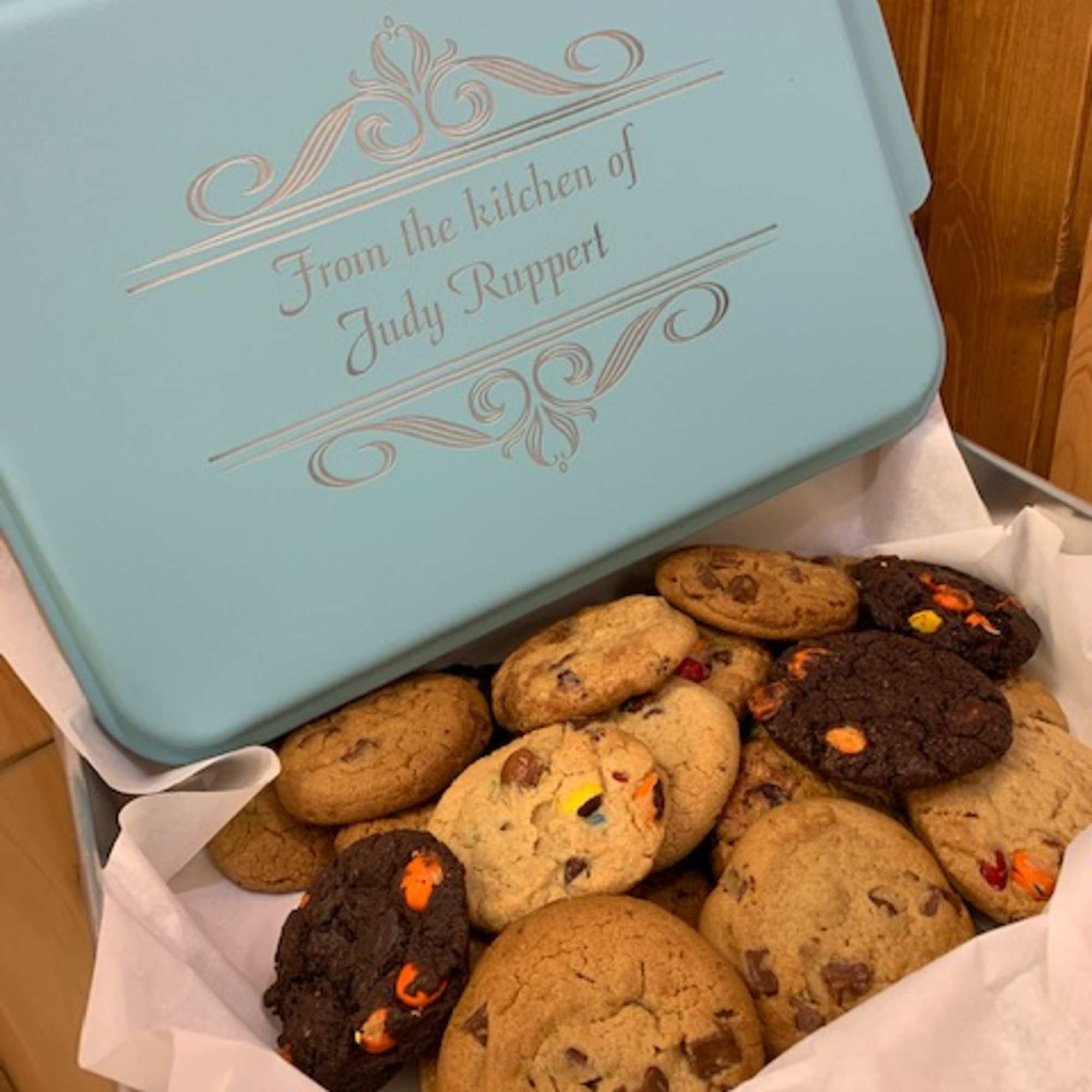 A blue cookie tin filled with assorted cookies