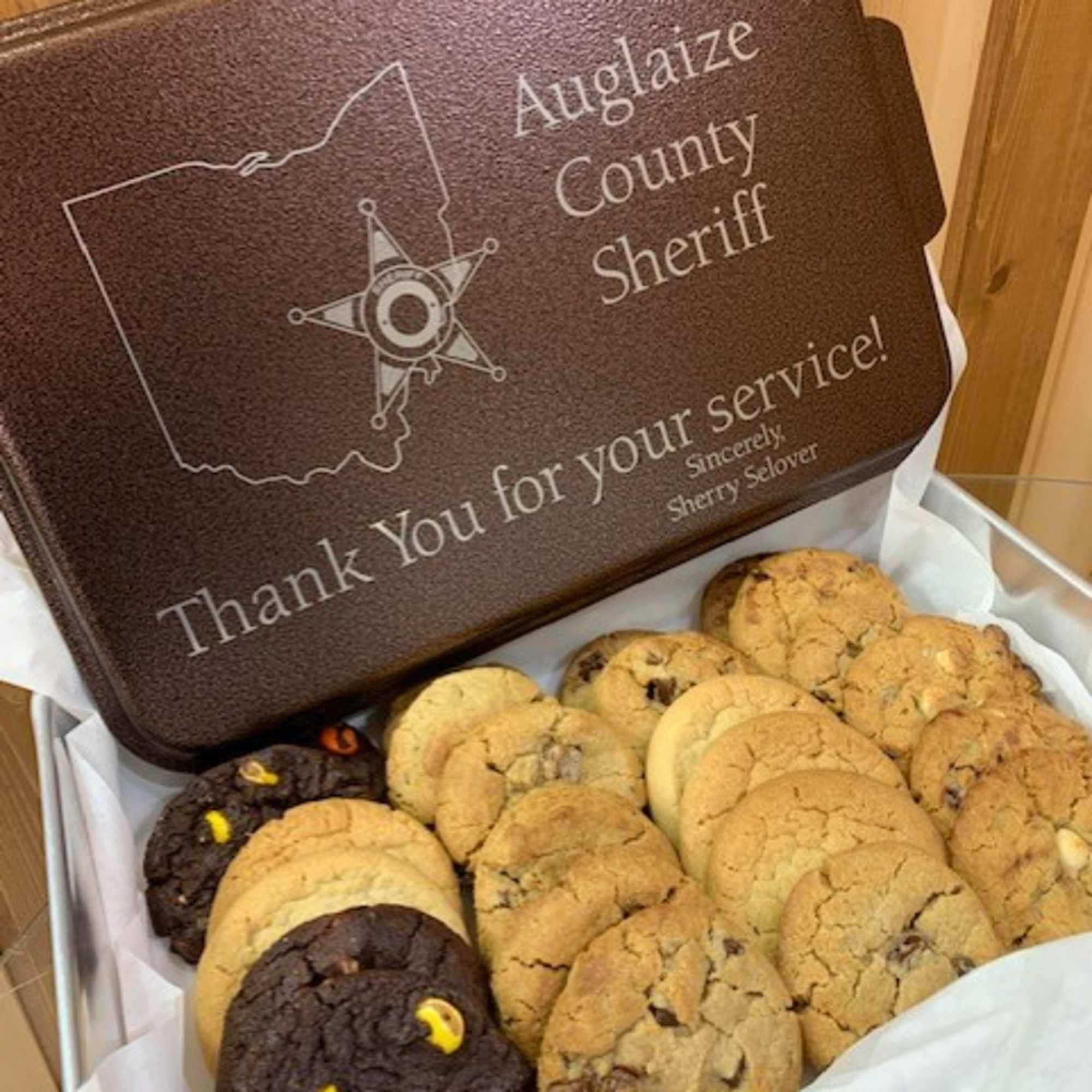Gift box of assorted cookies with a sheriff-themed lid
