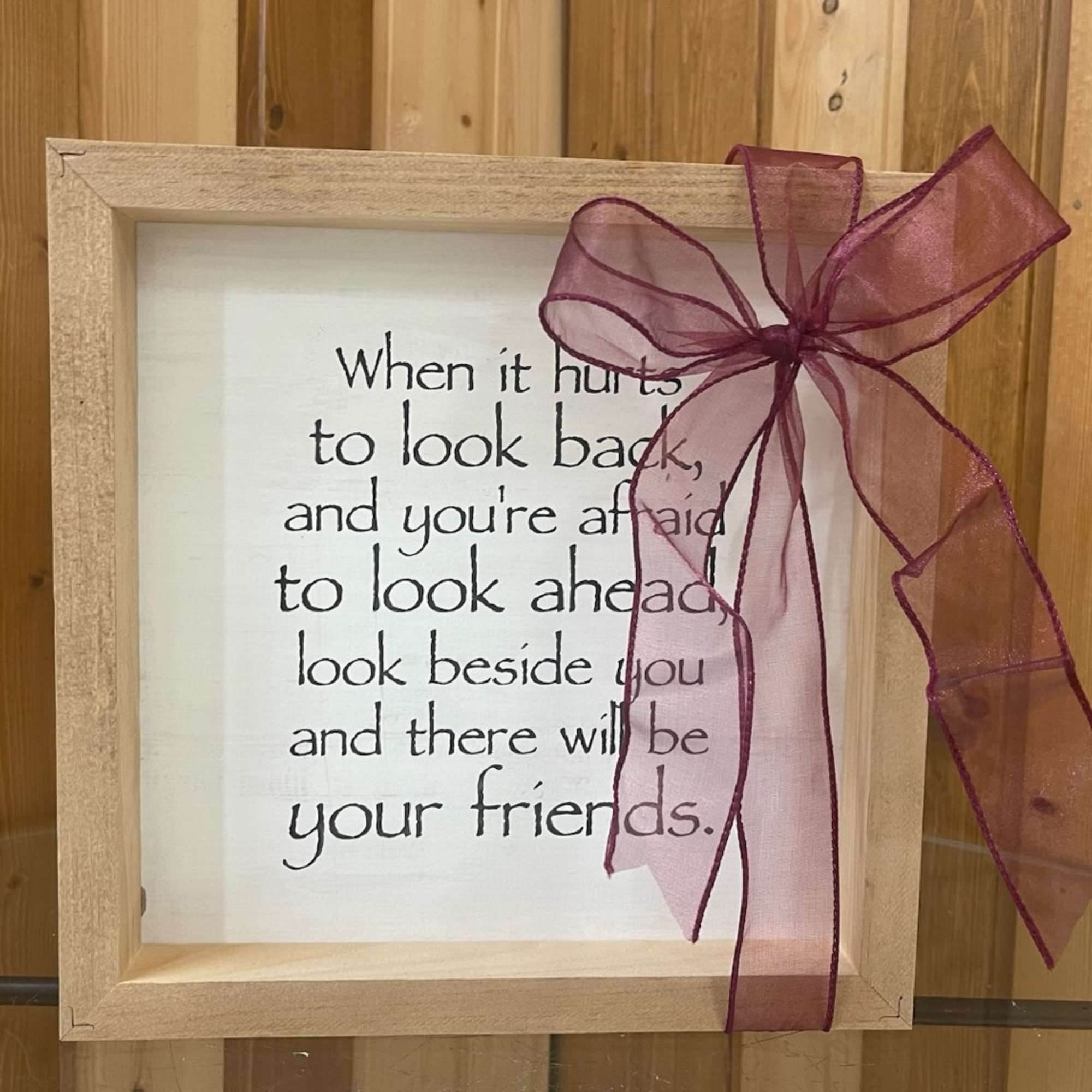 Framed quote print with a burgundy ribbon bow