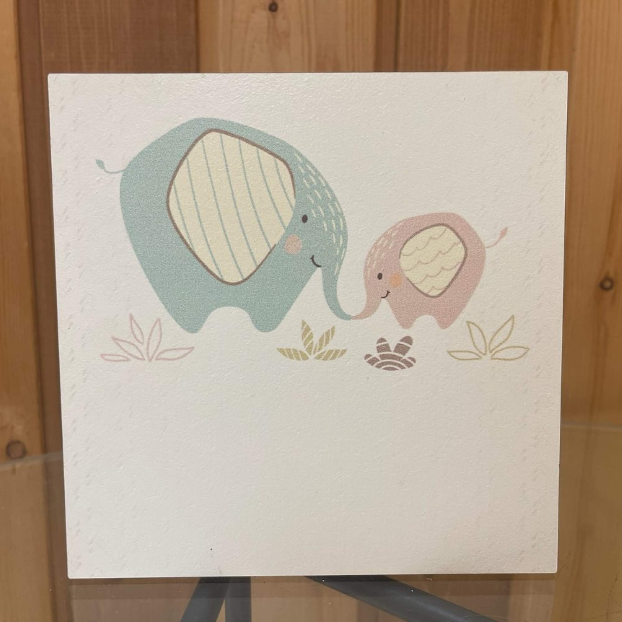 A card with two cartoon elephants touching trunks.