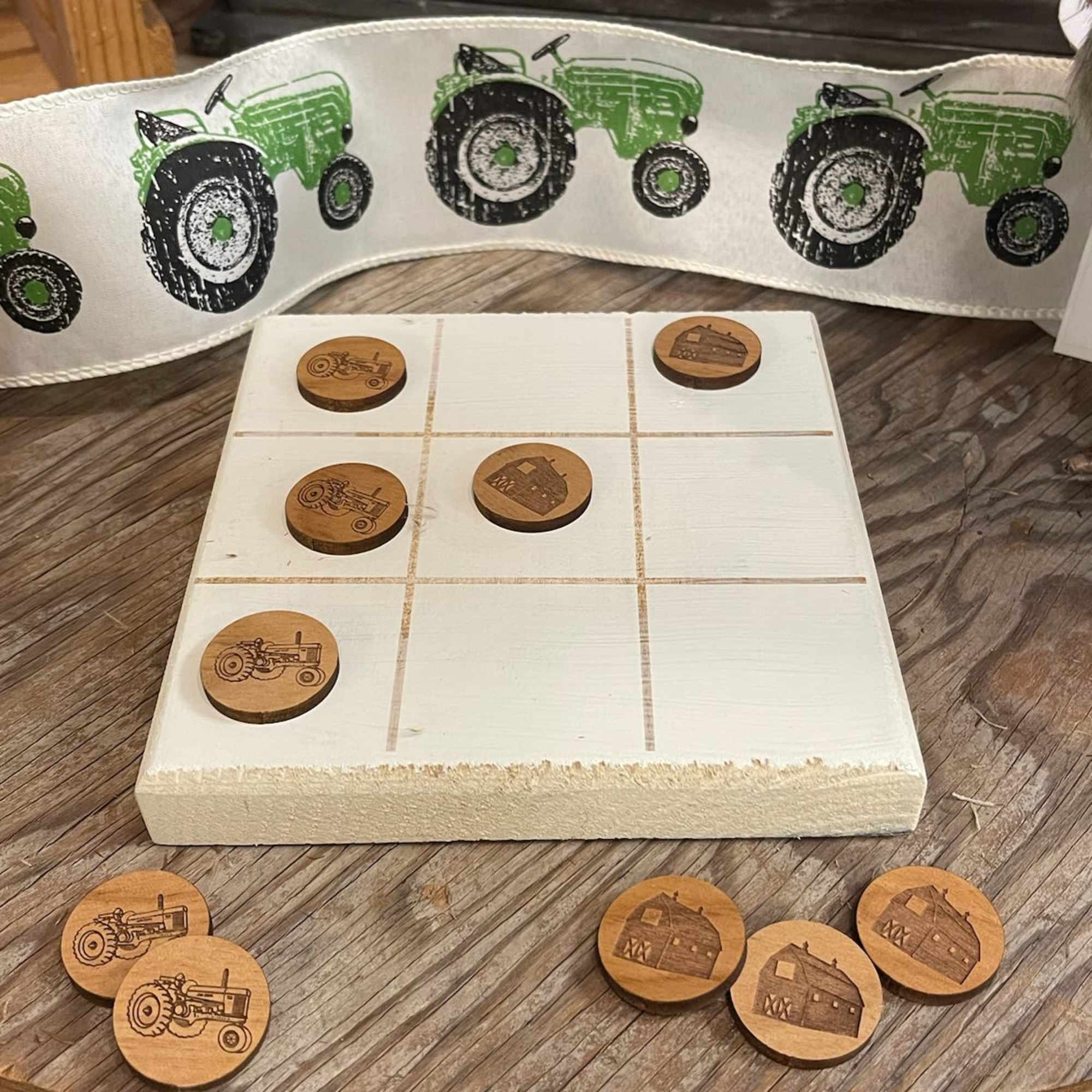 Farm-themed tic-tac-toe board with tractor and barn tokens