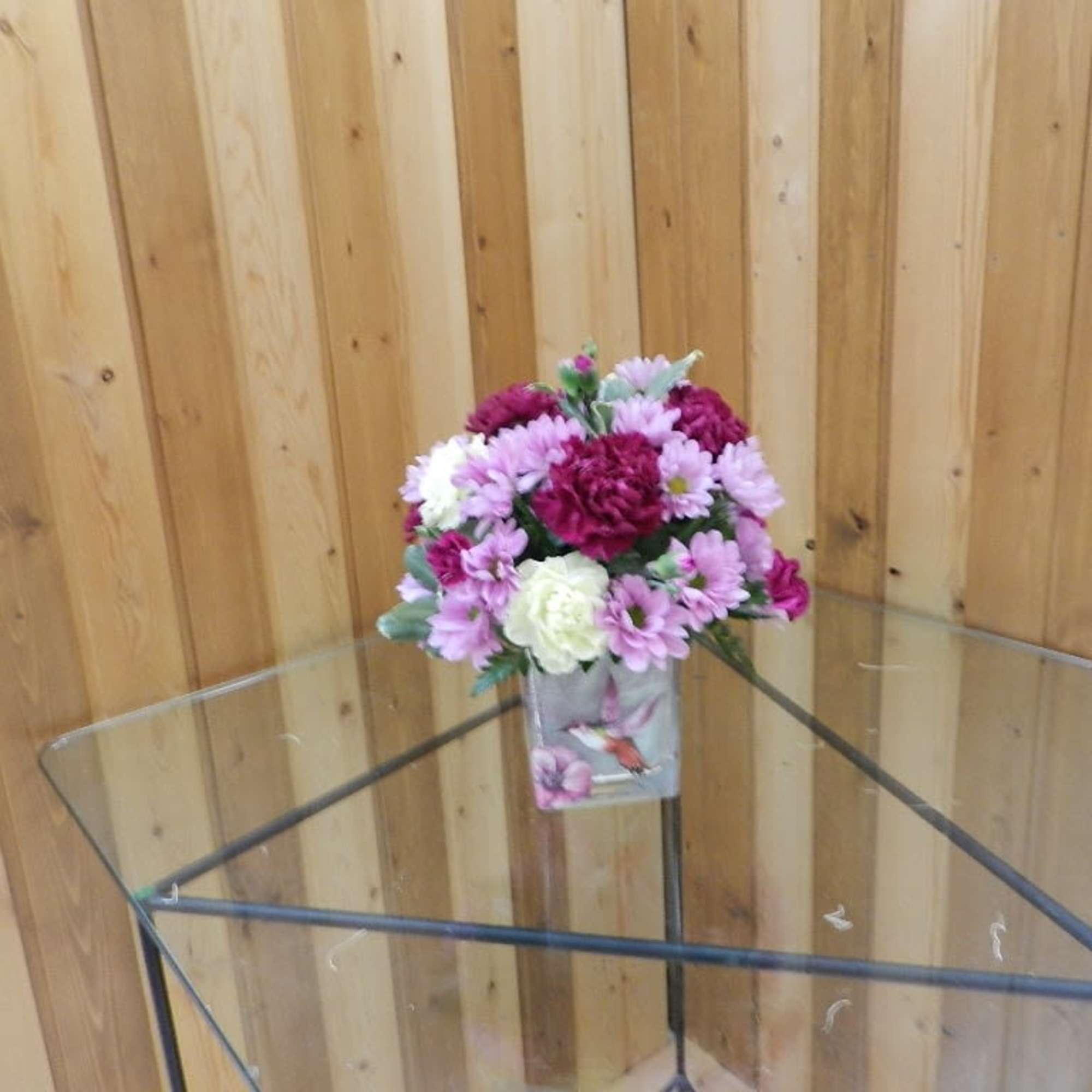 Small bouquet of pink and white flowers in a decorative vase