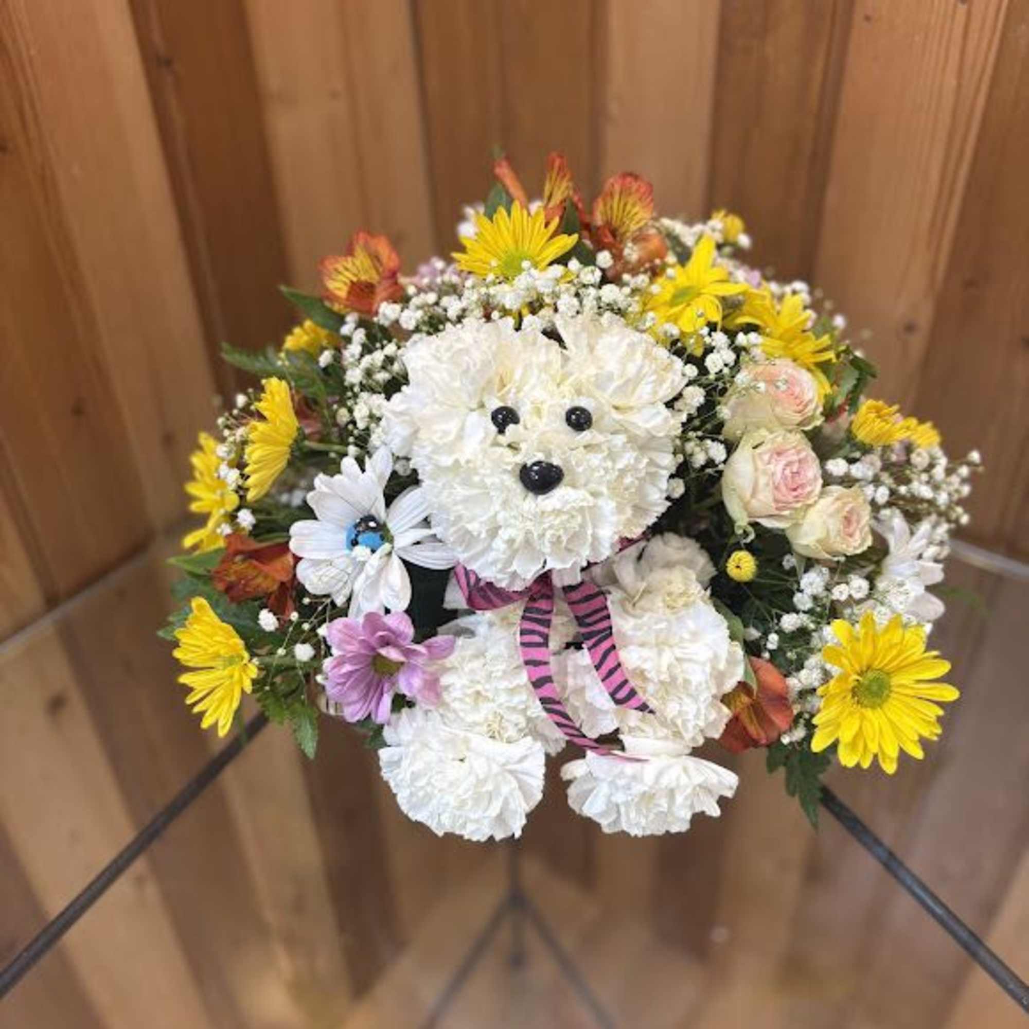 Teddy bear made of white flowers with a pink ribbon and mixed blooms