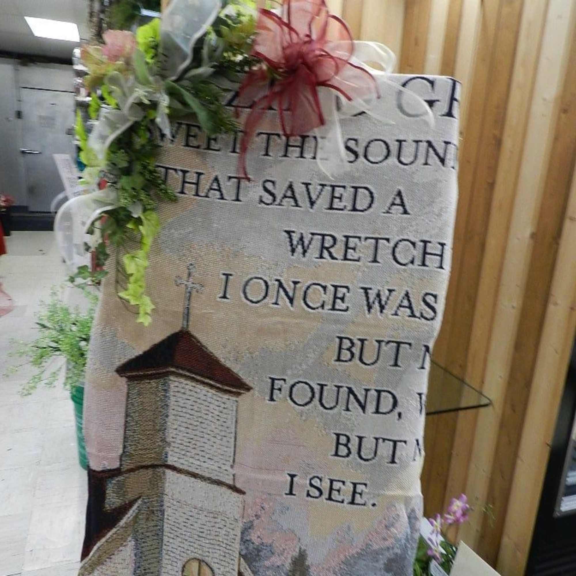 Decorative memorial banner with floral accents and ribbon bows