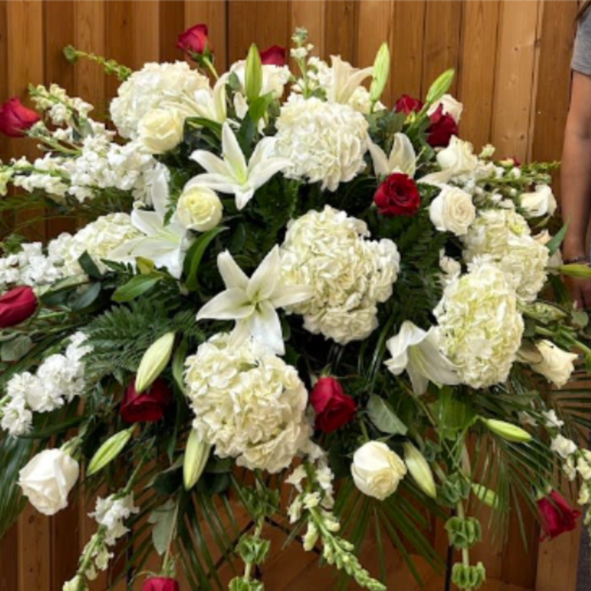 Large white and red floral spray with lilies and roses