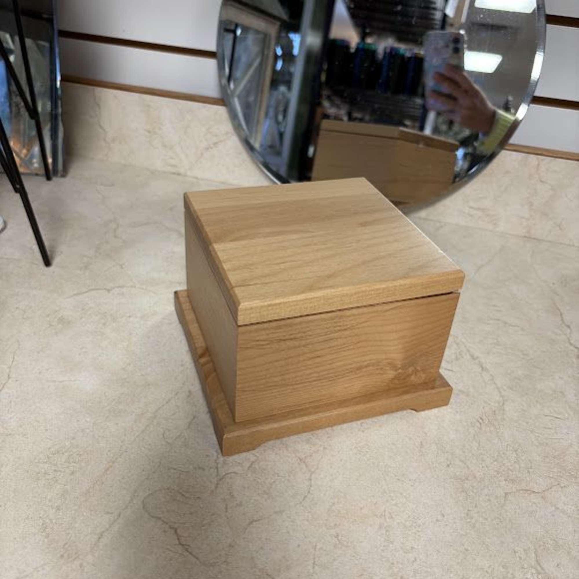 Wooden cremation urn on a store floor