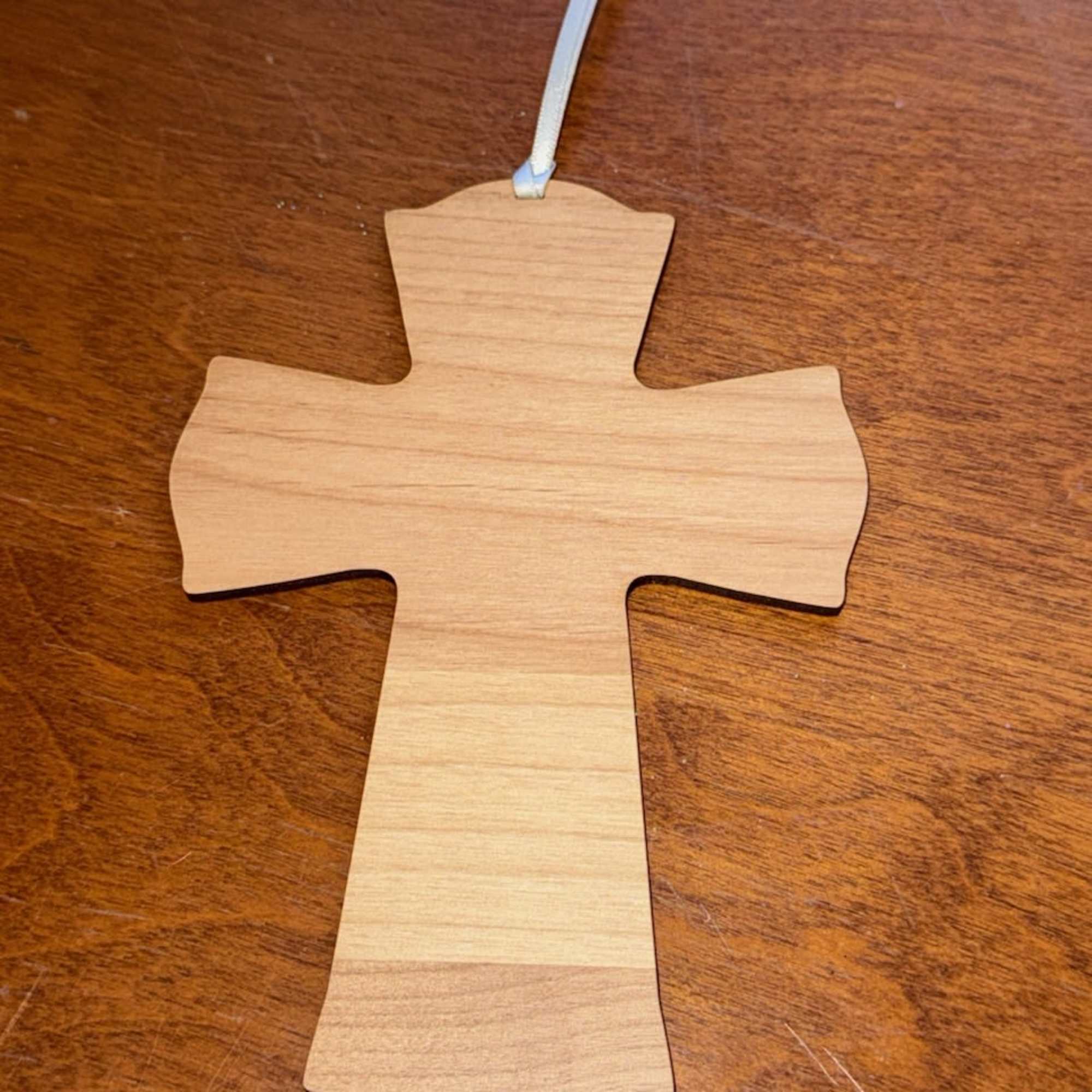 Wooden cross ornament with a ribbon hanger