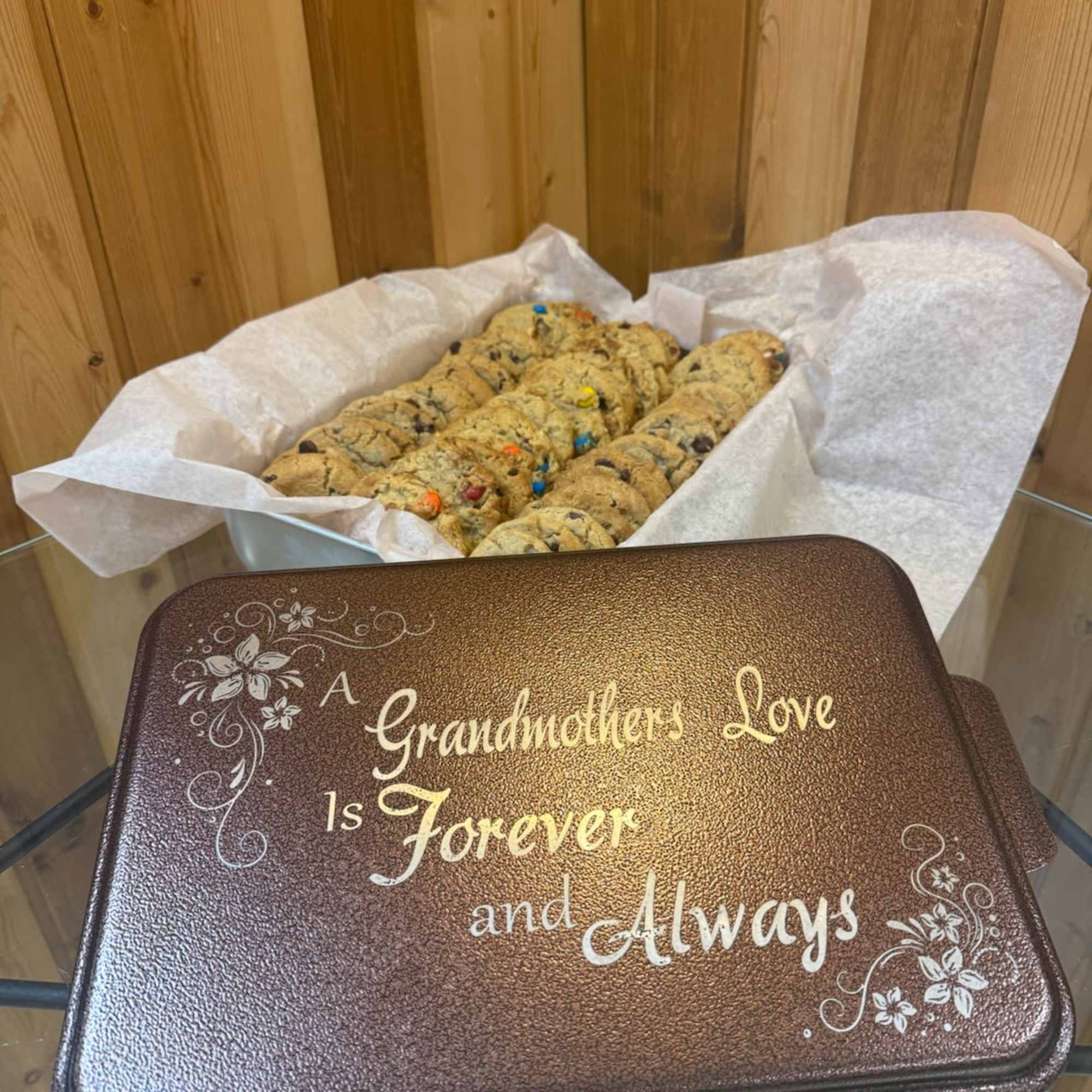 Tray of cookies behind a decorative tin with a grandmother tribute message