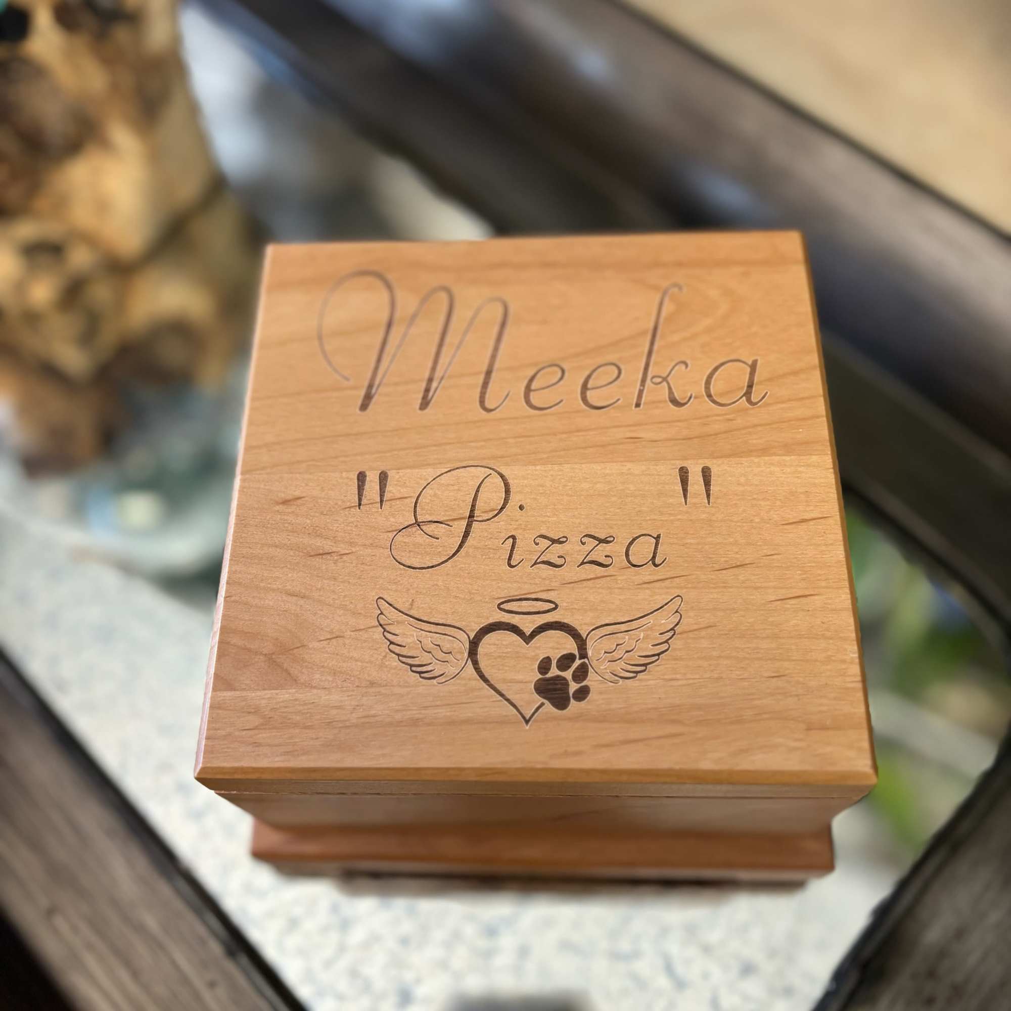 Wooden pet urn box engraved with "Meeka Pizza" and a paw print heart
