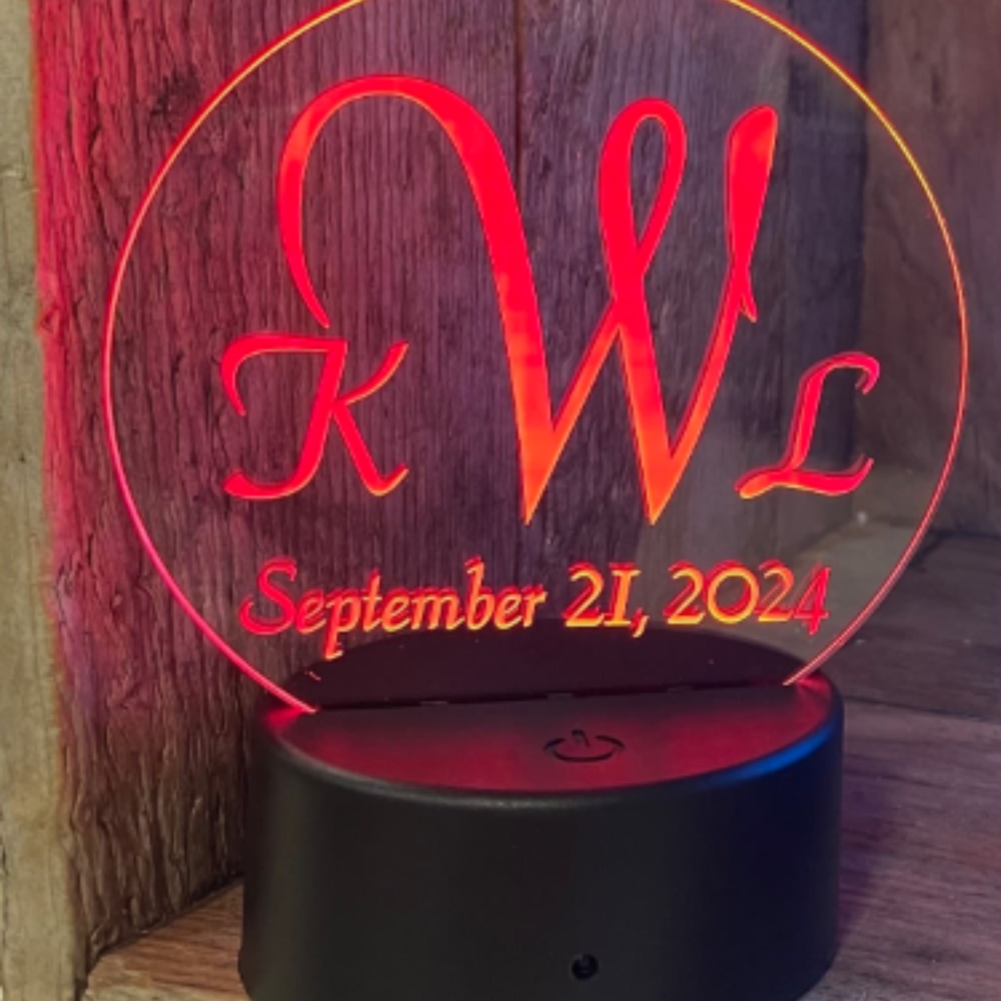 Personalized LED acrylic sign with initials and date on a black base