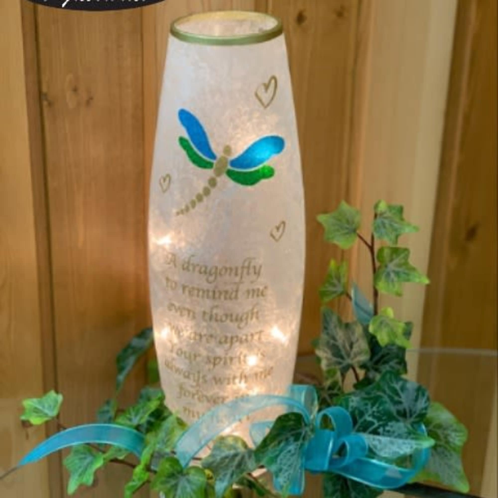 Lit memorial lantern with dragonfly design and ivy garland