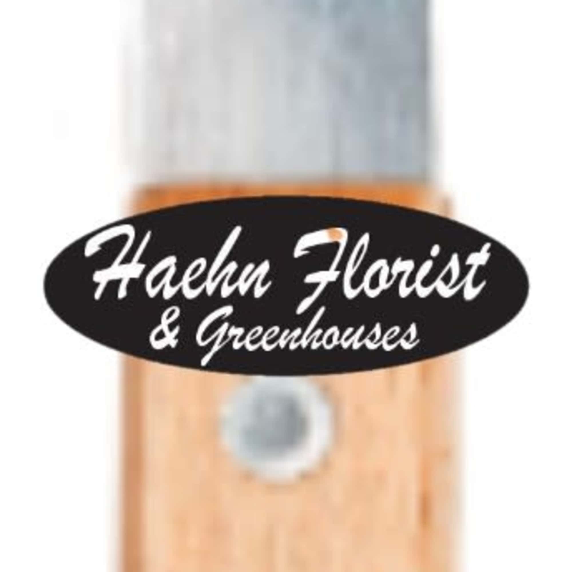 Wood-handled garden fork with metal tines and a florist logo sticker