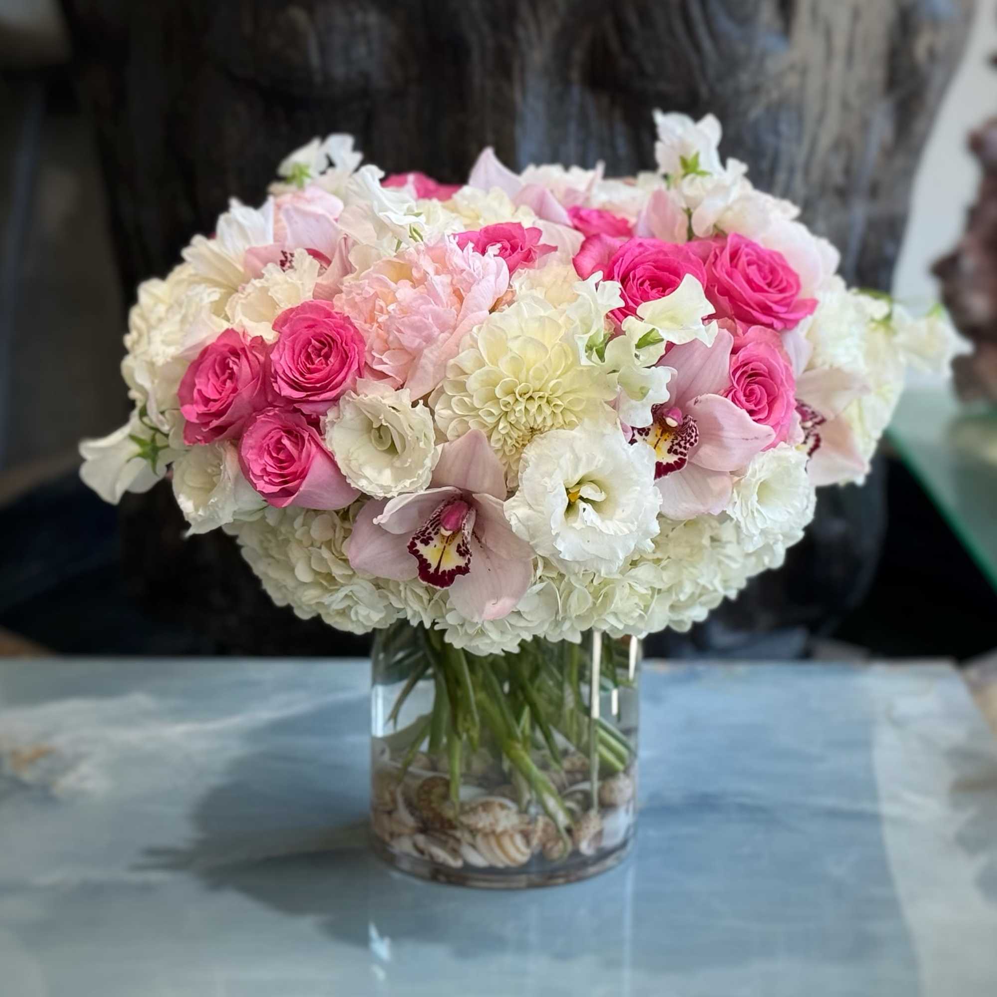 Pink and white bouquet in a clear glass vase