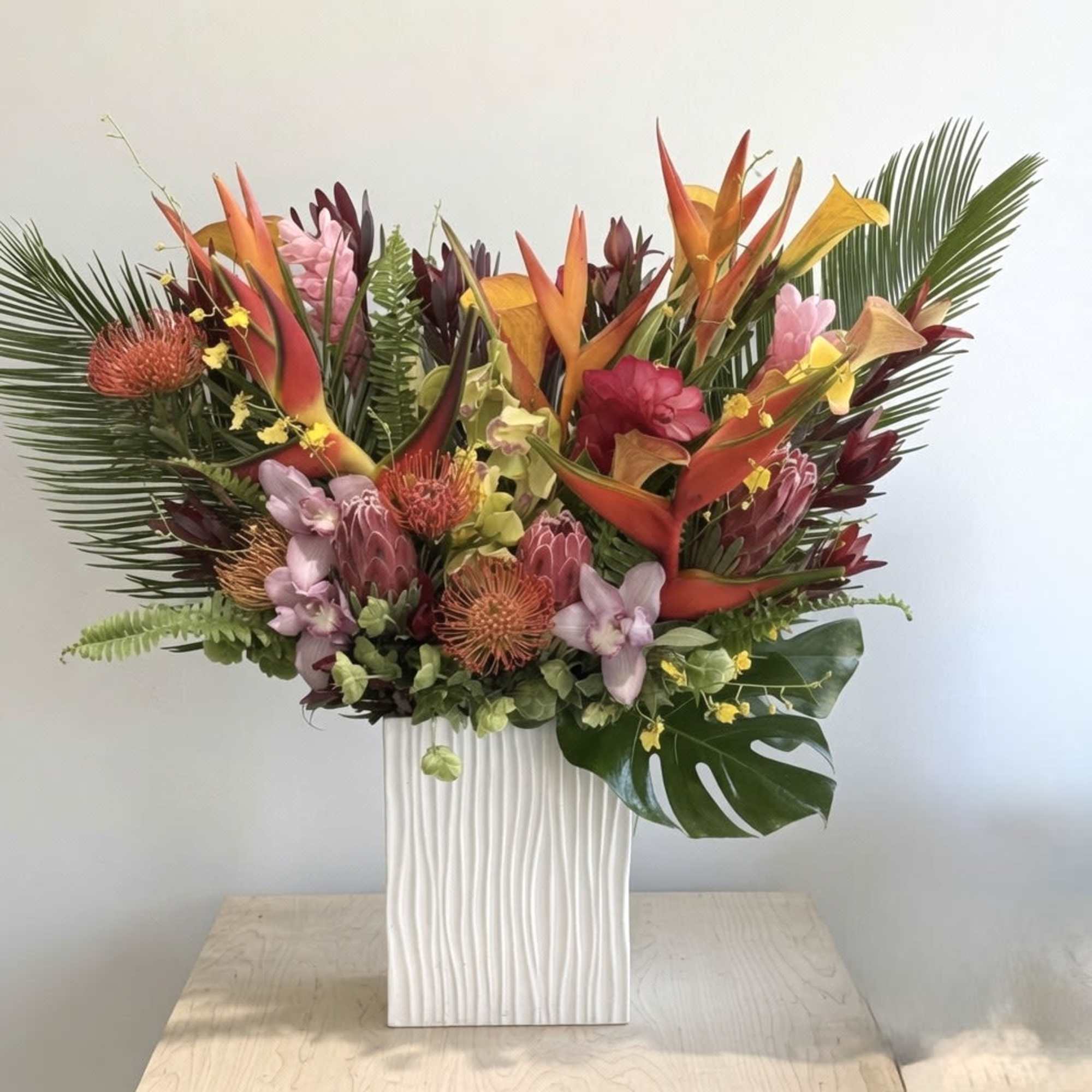 This arrangement is a bold celebration of the tropics, combining vibrant color