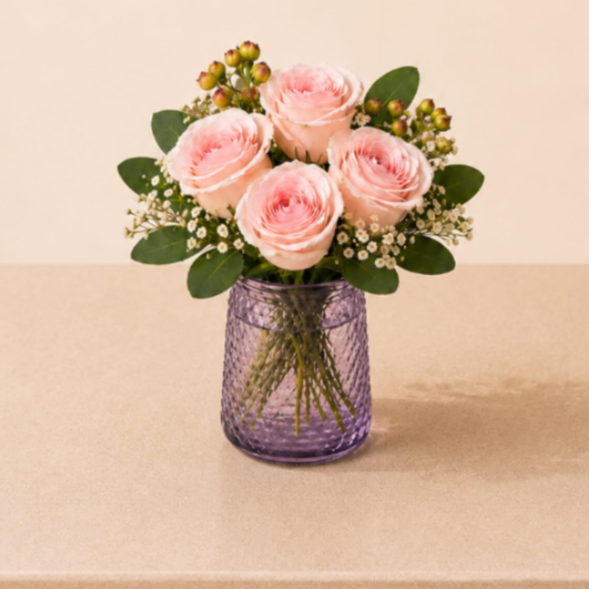A charming and elegant arrangement featuring four premium roses, beautifully accented with