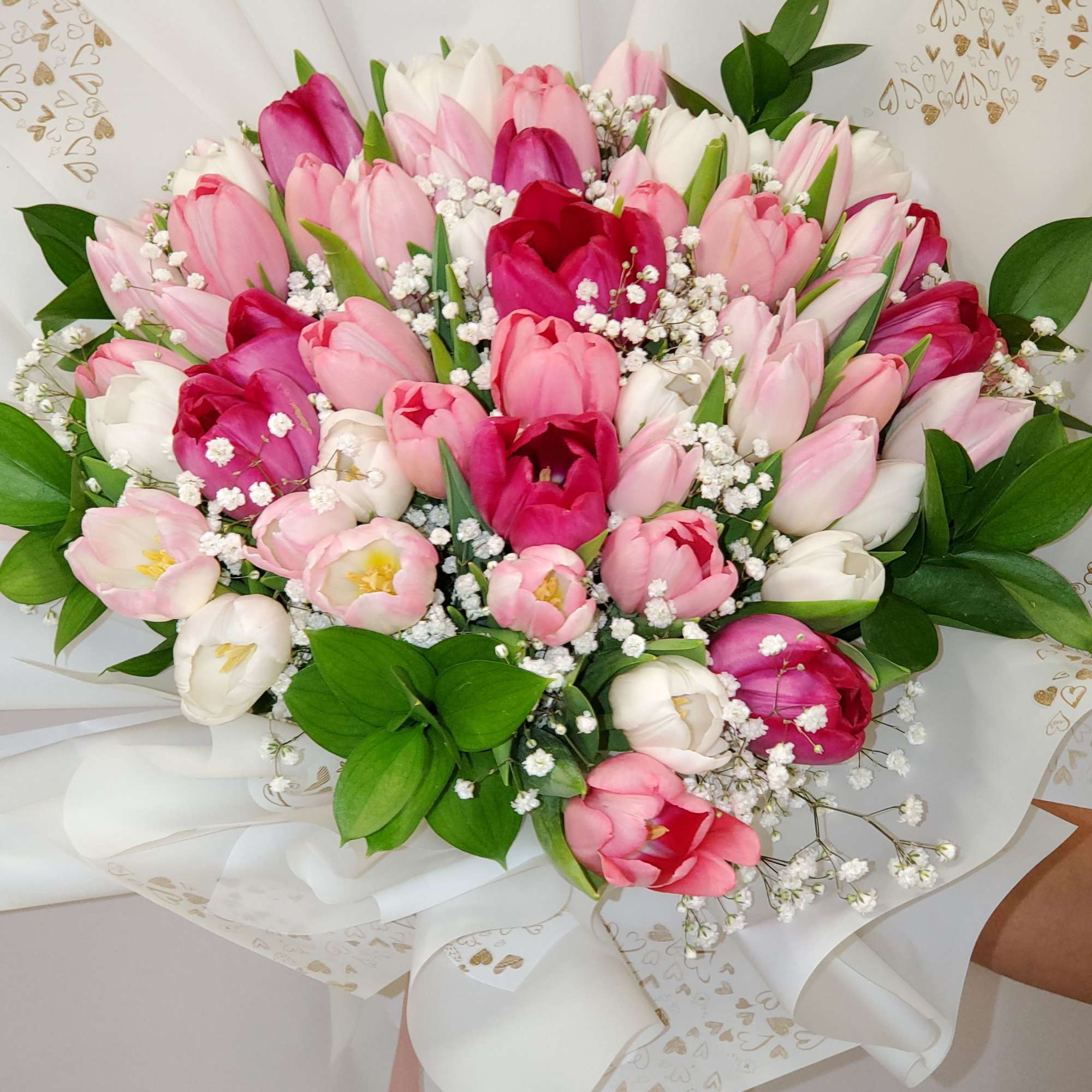 Bouquet of pink, white, and magenta tulips with baby's breath