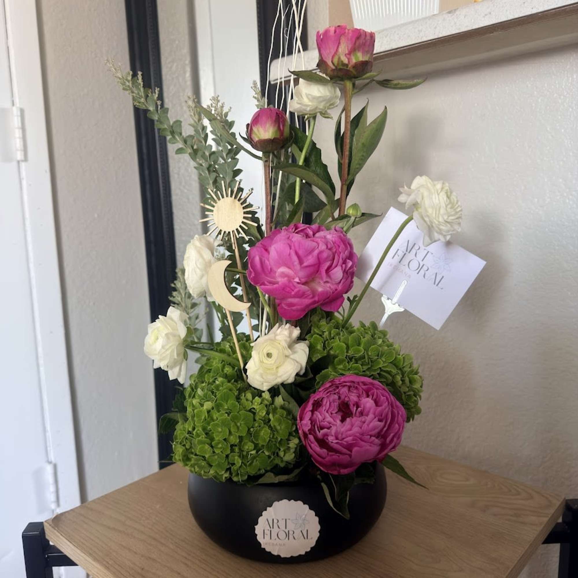 An elegant ikebana arrangement featuring the delicate beauty of peonies, the charming