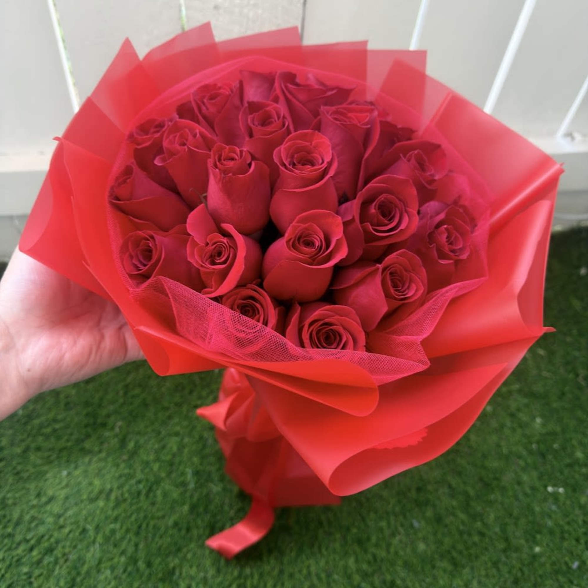 An elegant and sophisticated arrangement of fresh red roses, designed to express