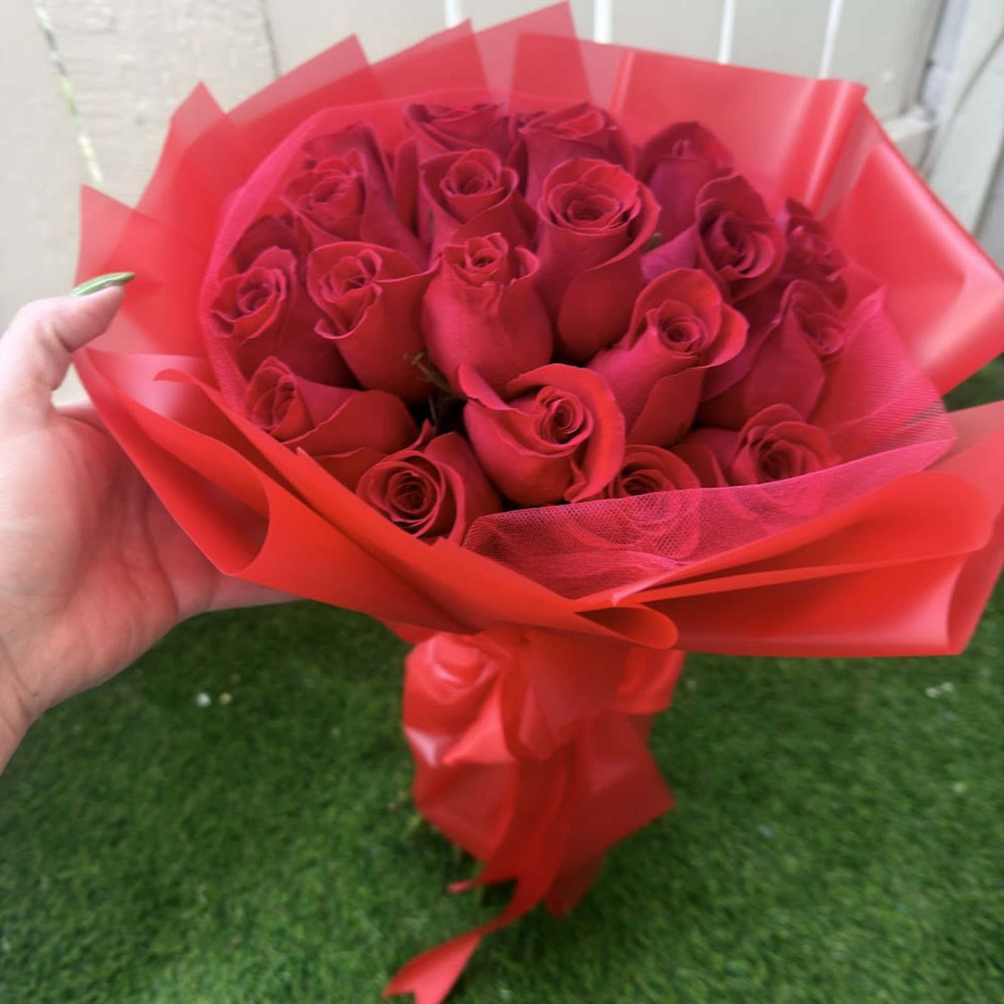 An elegant and sophisticated arrangement of fresh red roses, designed to express