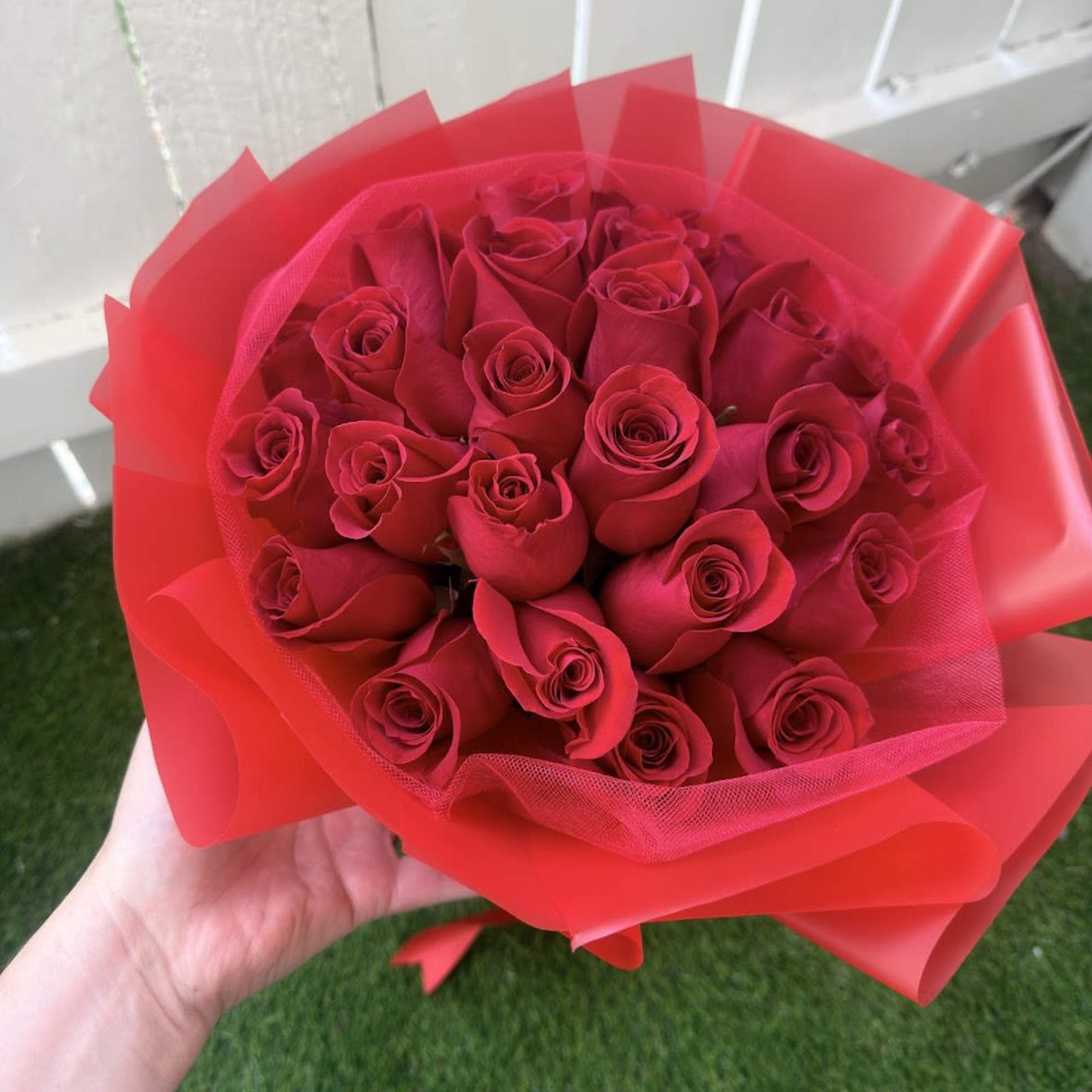 An elegant and sophisticated arrangement of fresh red roses, designed to express