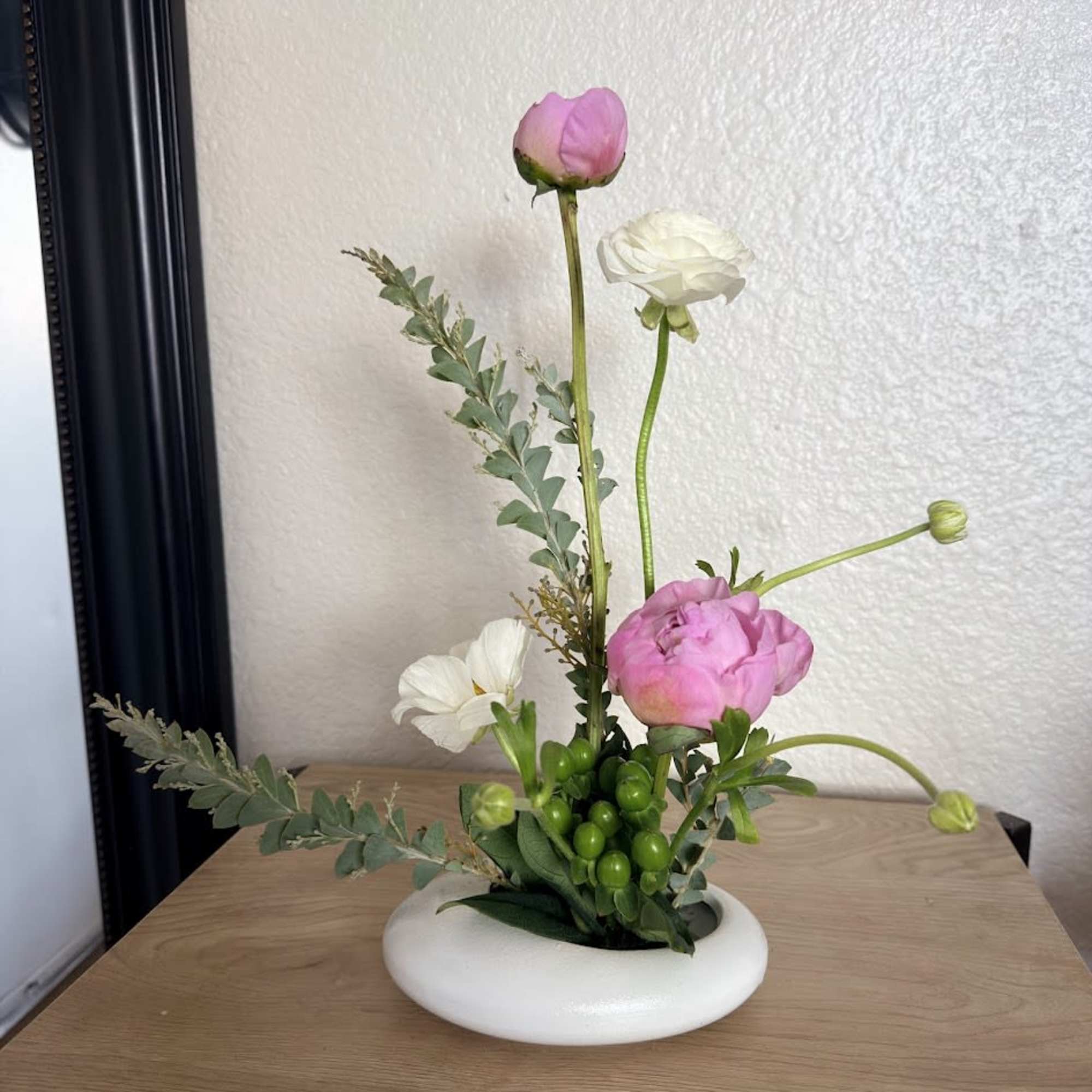 A delicate and sophisticated ikebana arrangement designed to capture the essence of