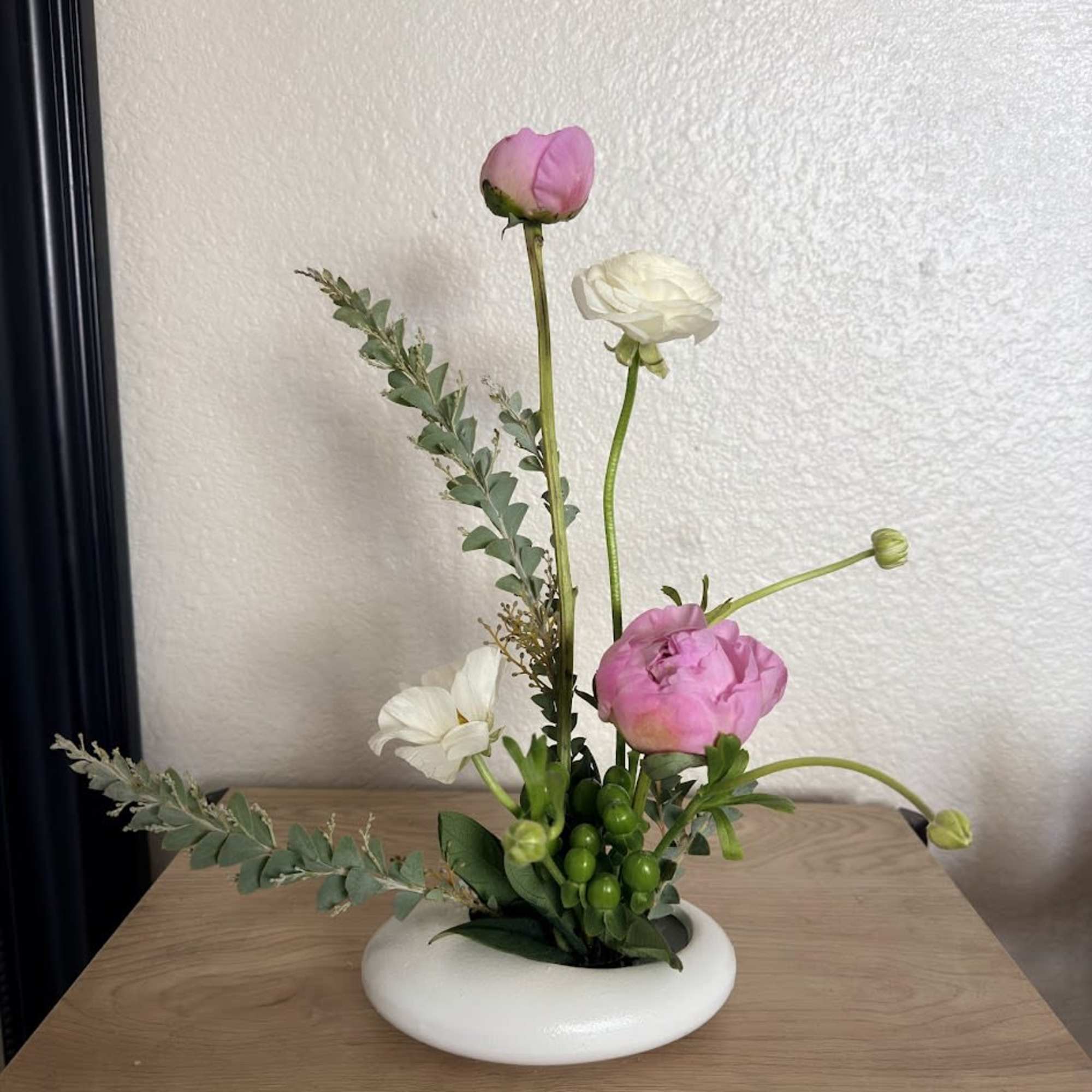 A delicate and sophisticated ikebana arrangement designed to capture the essence of