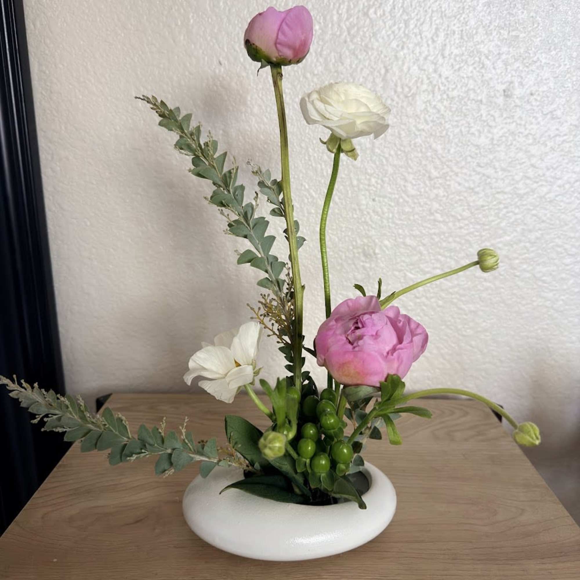 A delicate and sophisticated ikebana arrangement designed to capture the essence of