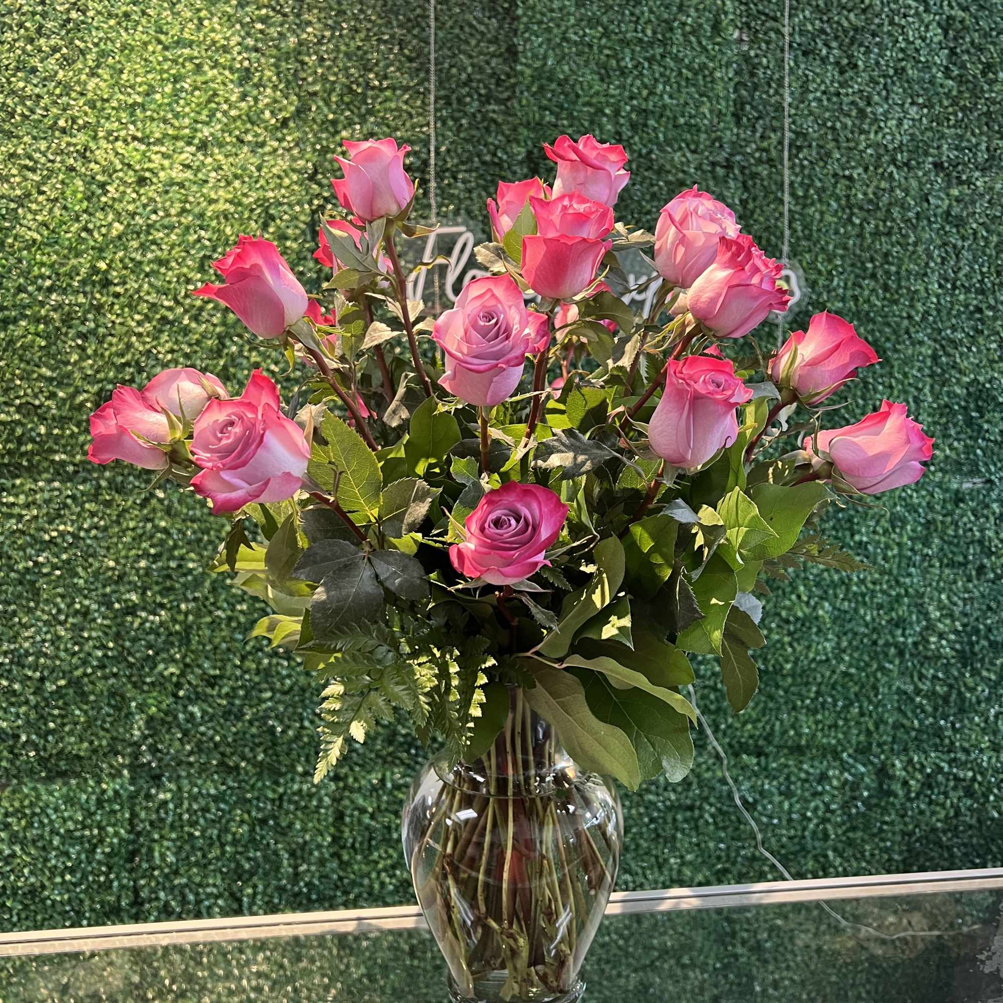 Pink roses arranged in a clear glass vase