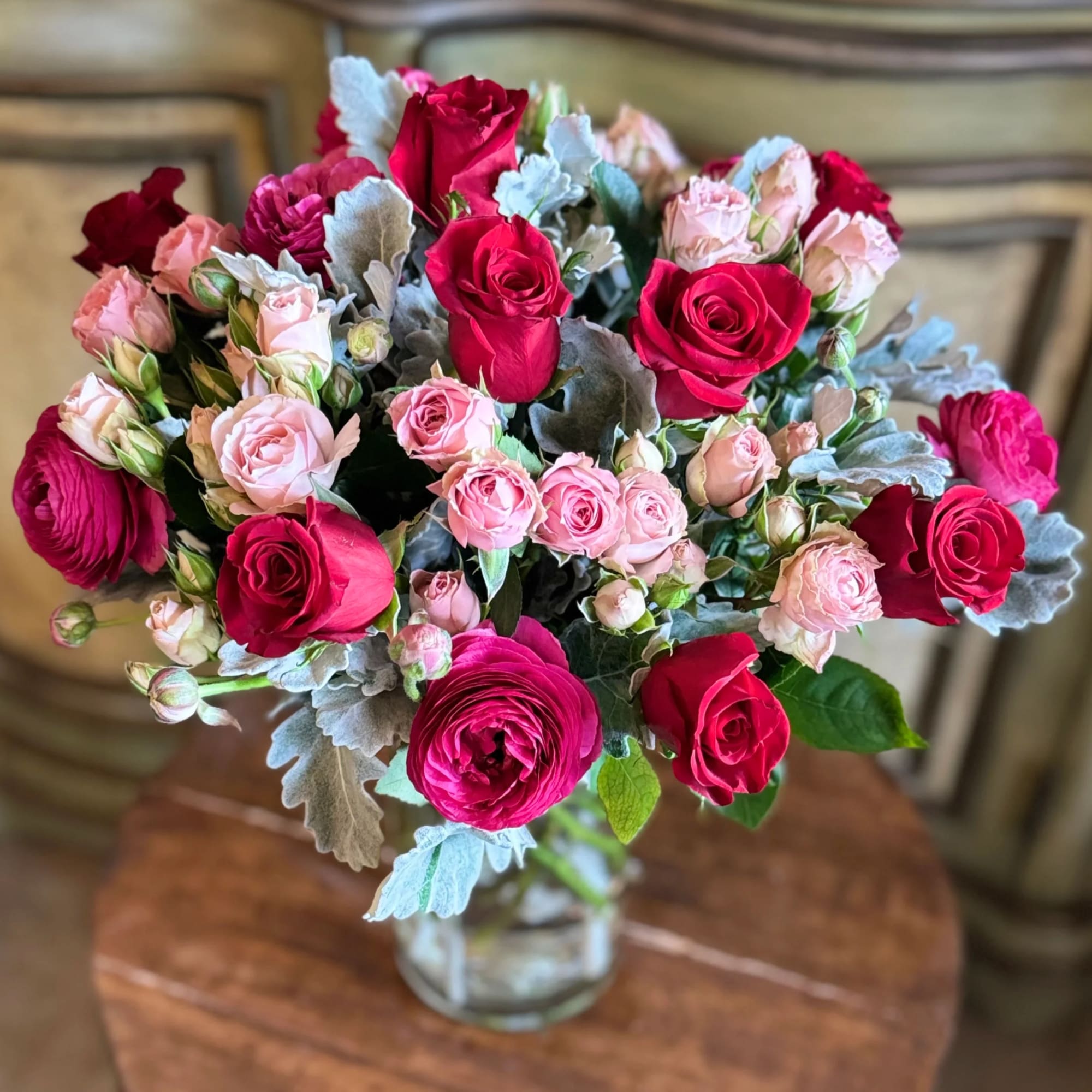 Bouquet of pink and red roses in a clear glass vase