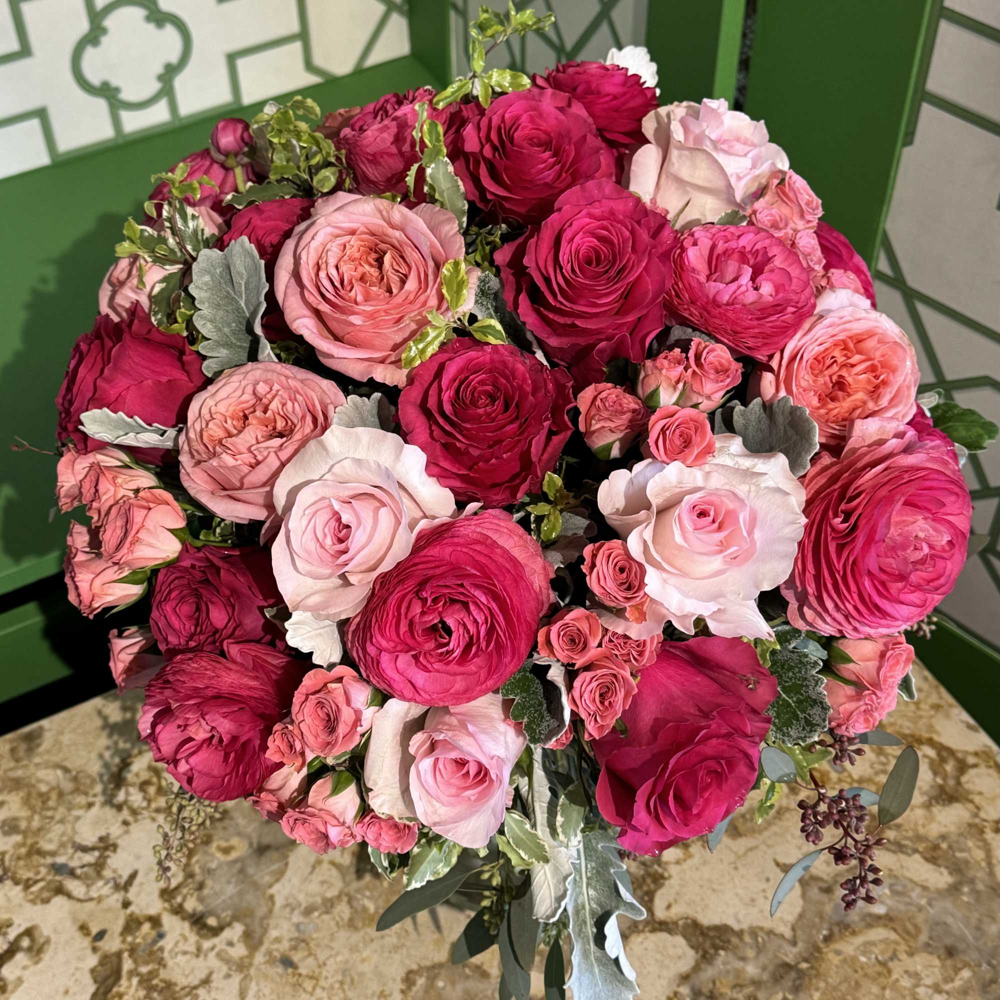 Bouquet of pink and magenta roses with silver foliage