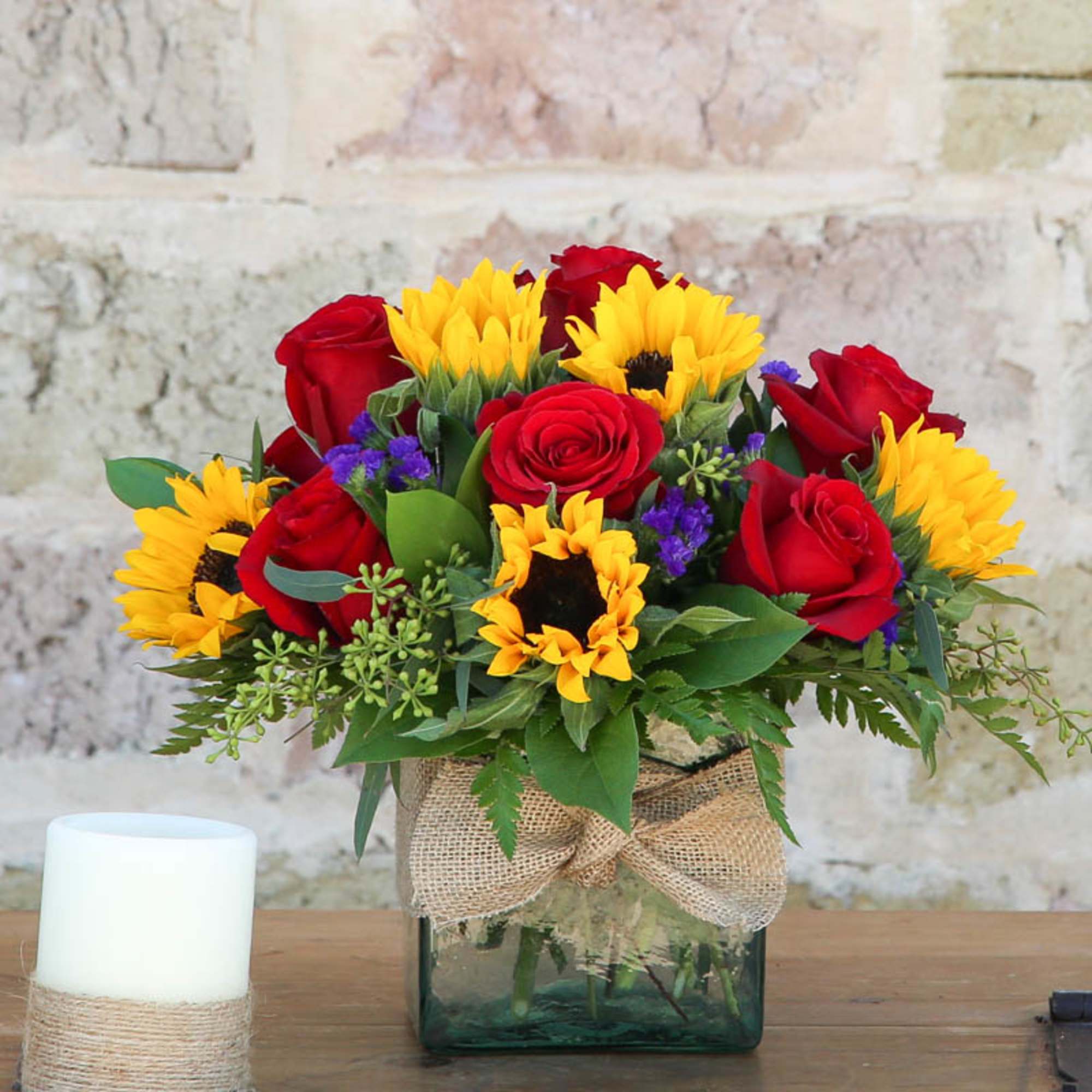 Red roses and yellow sunflowers in a glass vase with burlap ribbon, photo 2 of 2
