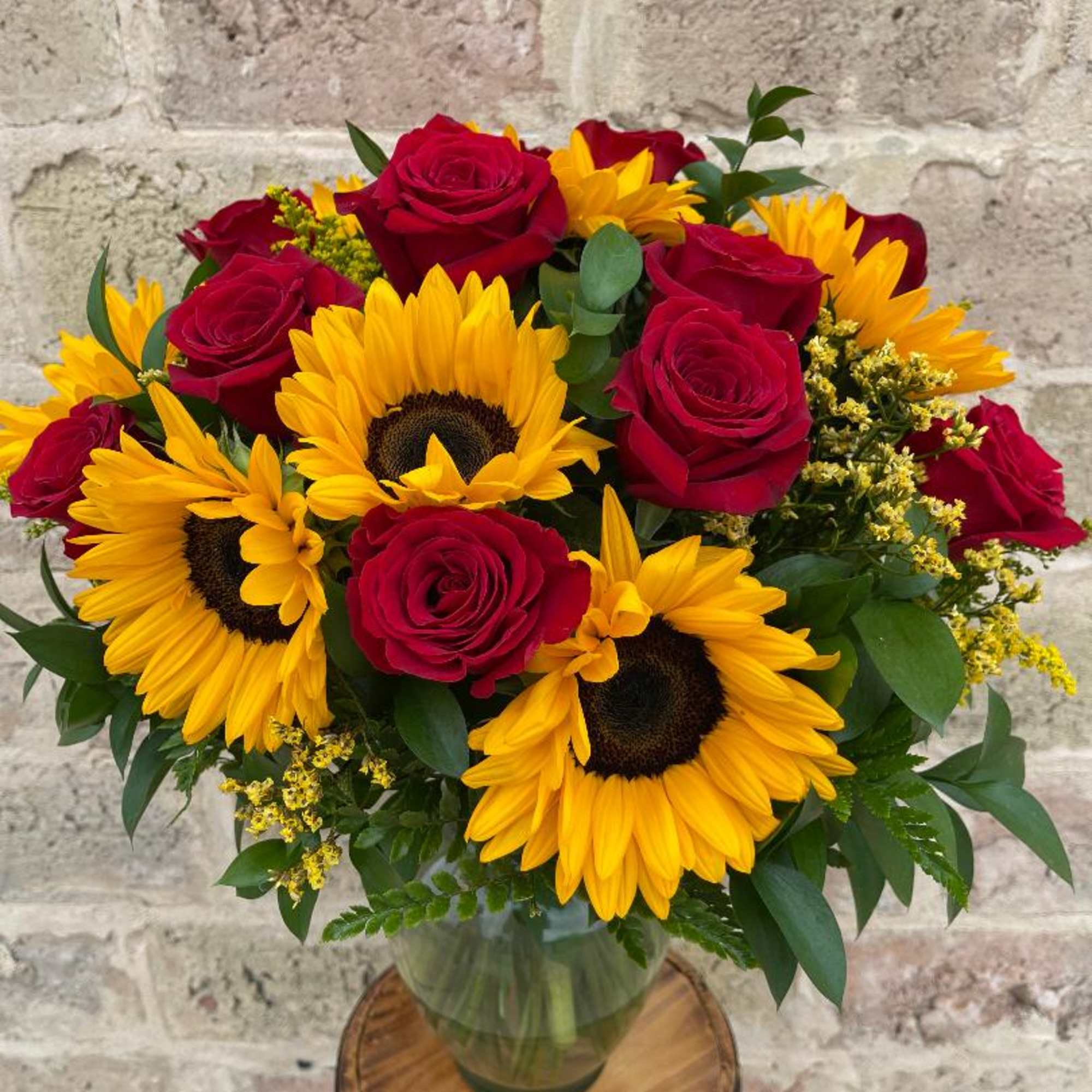 Bouquet of red roses and yellow sunflowers in a glass vase, photo 2 of 2