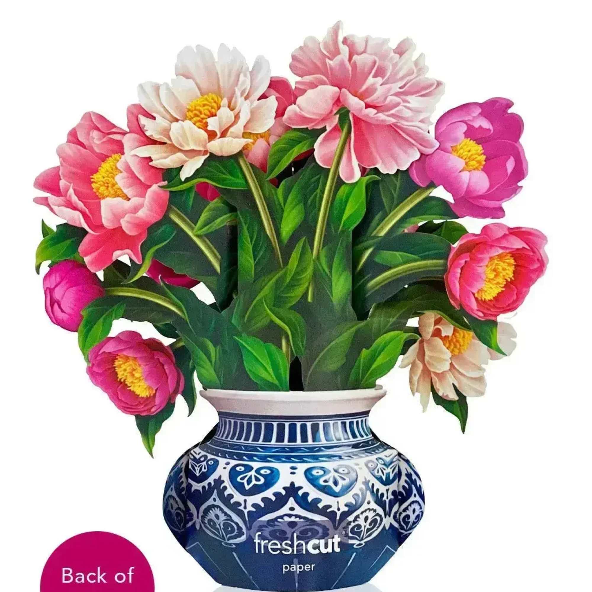 Pink and white flowers in a blue patterned vase