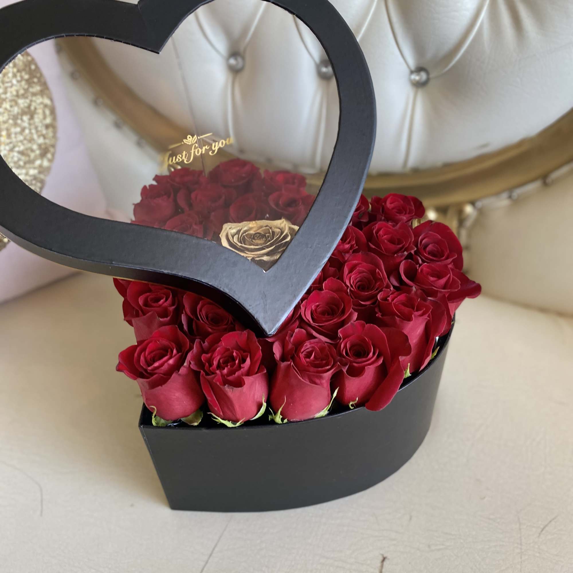 Heart-shaped box of red roses with a black frame