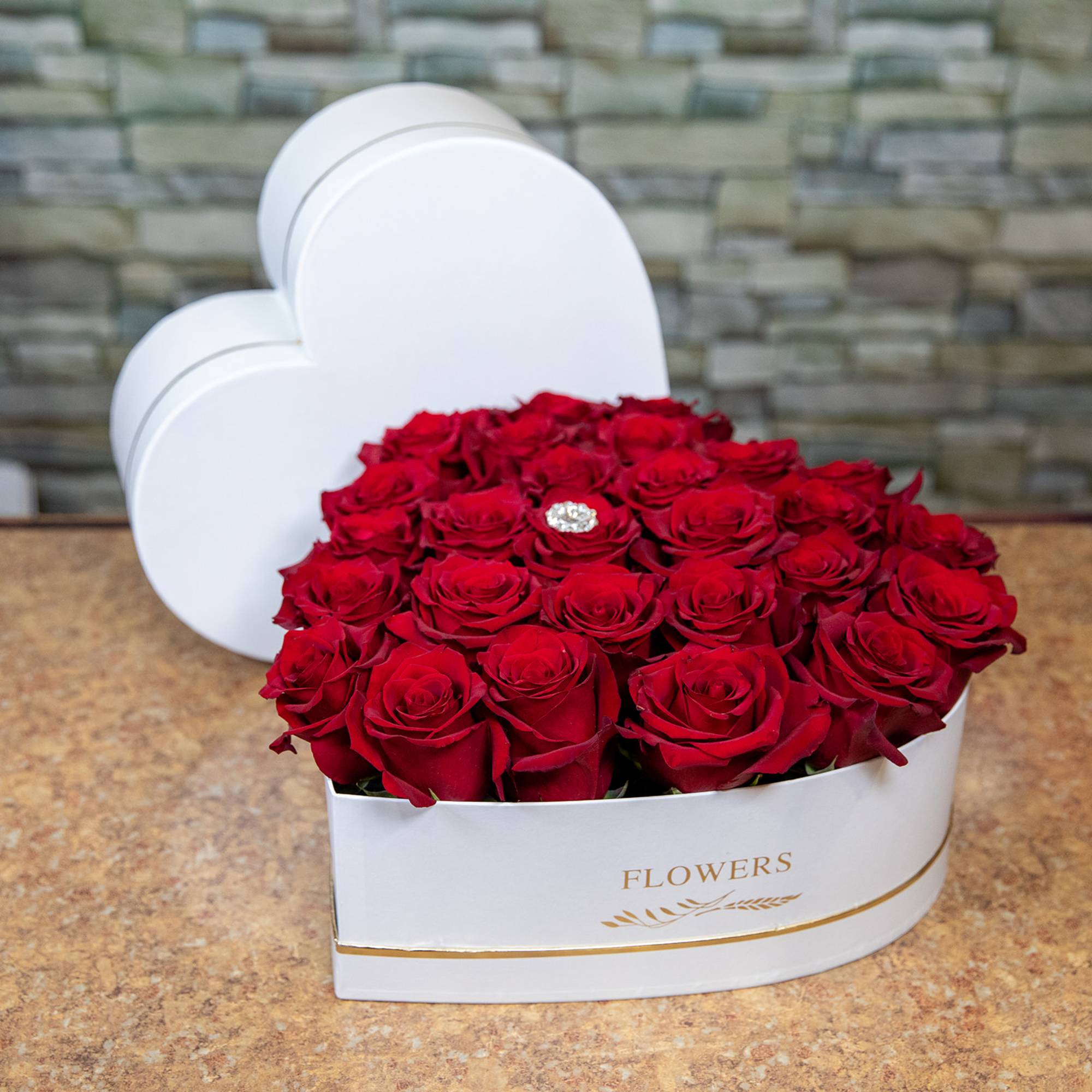 A sculpted heart of velvety red roses makes an unforgettable centerpiece for