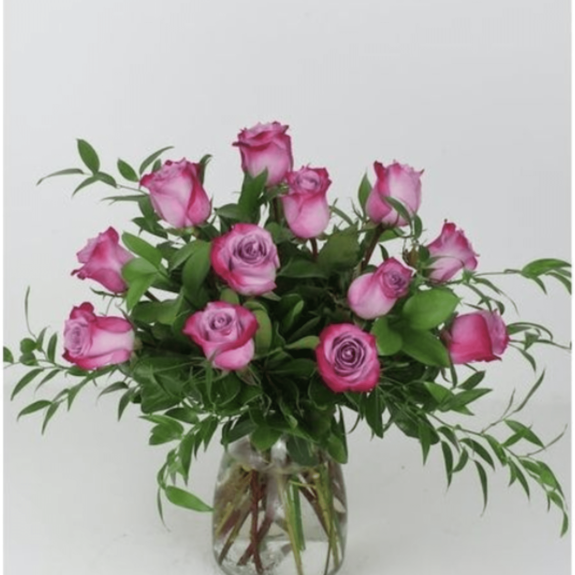 A loose, rounded cluster of purple roses-some with darker magenta edges-creates an