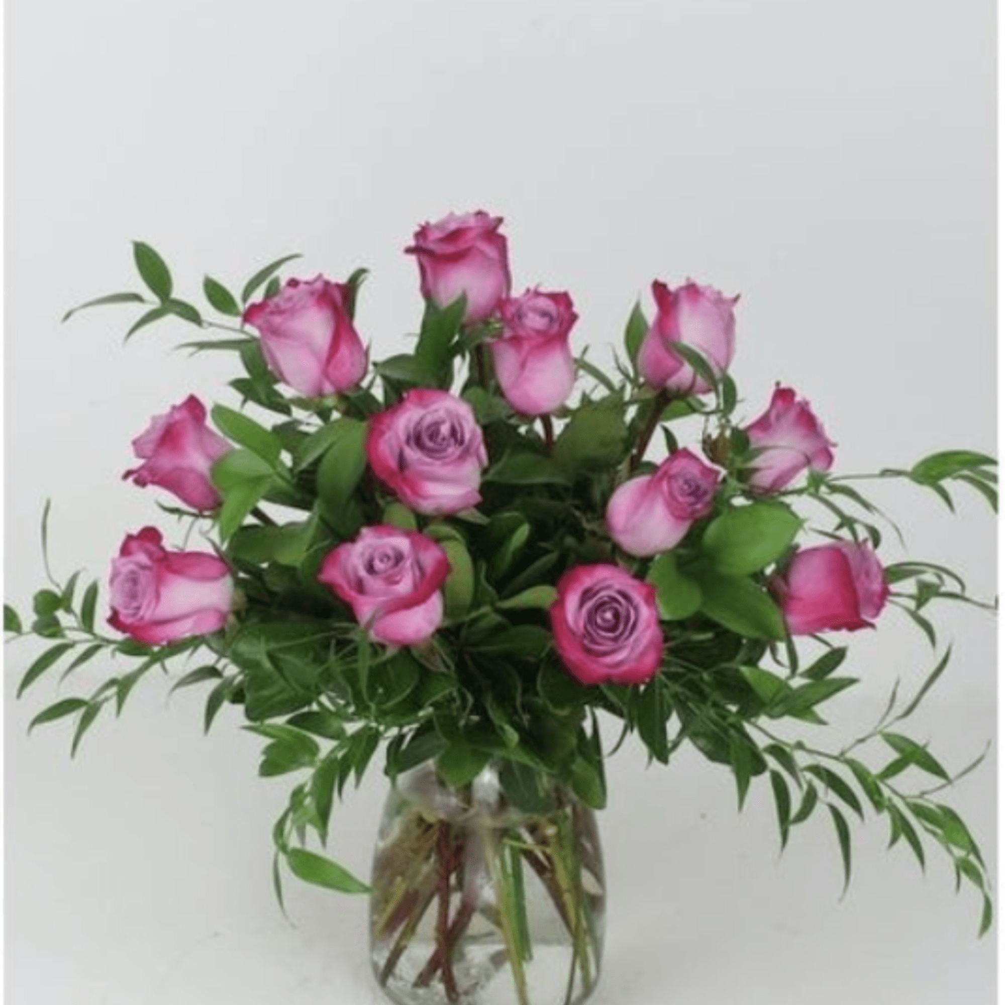 A loose, rounded cluster of purple roses-some with darker magenta edges-creates an