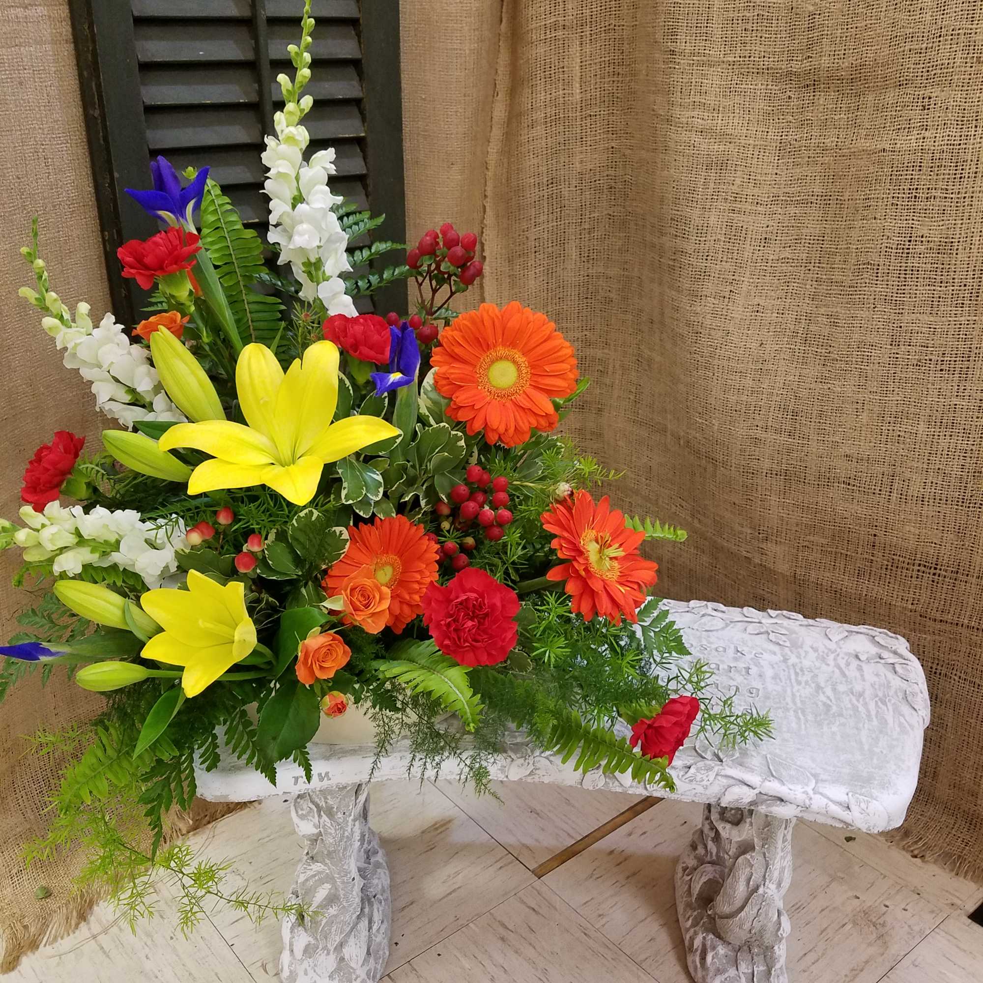 Bright mixed flower arrangement with lilies, gerberas, snapdragons, and roses