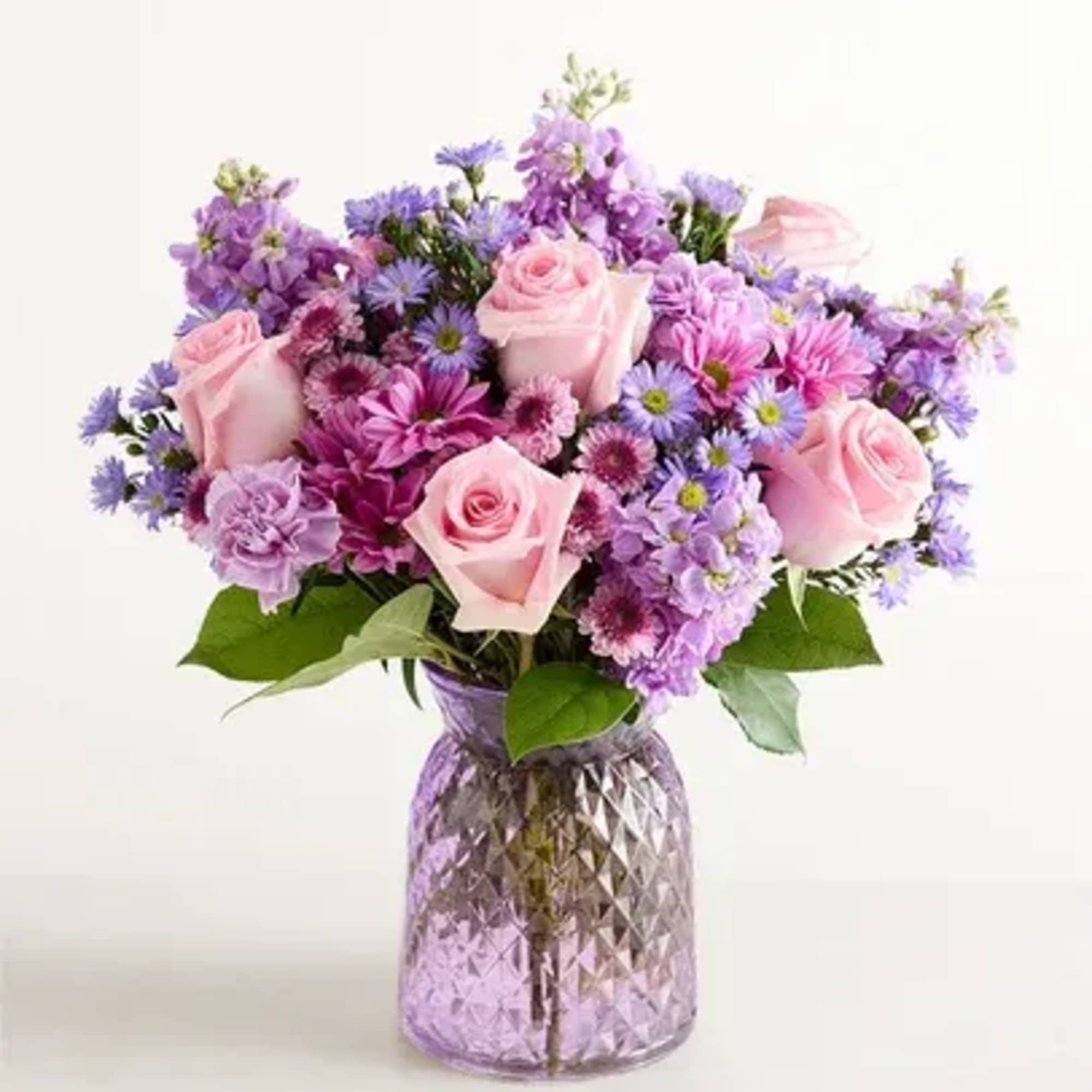 Purple vase, pink roses, lavender carnations, lavender daisies, purple monte, lavender stock
