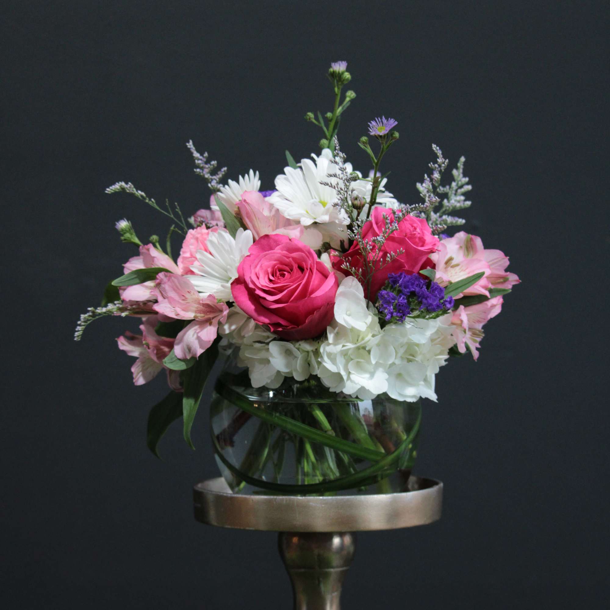 An airy free flowing arrangement full of spring color and life! 