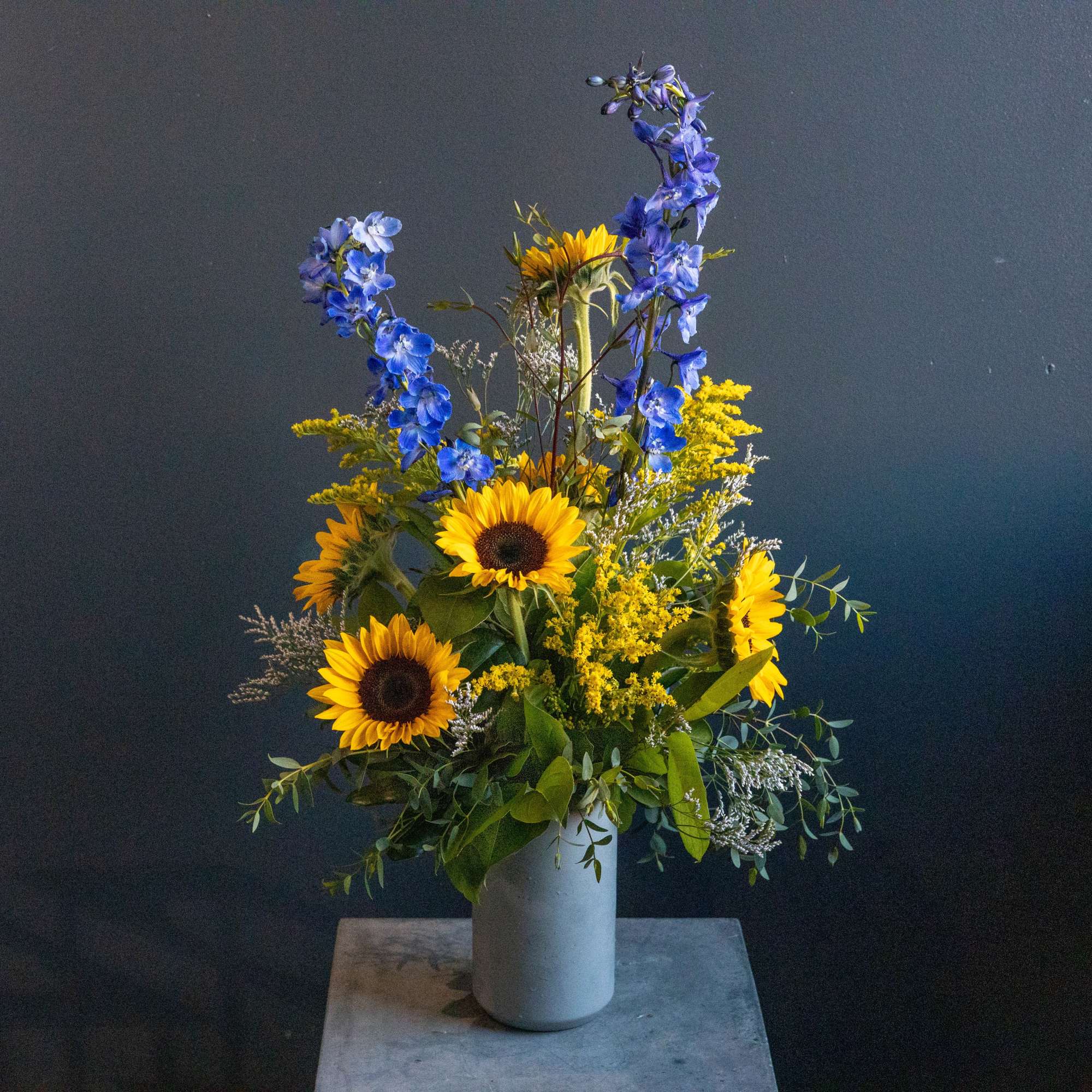 This fun fresh sunshine arrangement with it's denim blues is the perfect