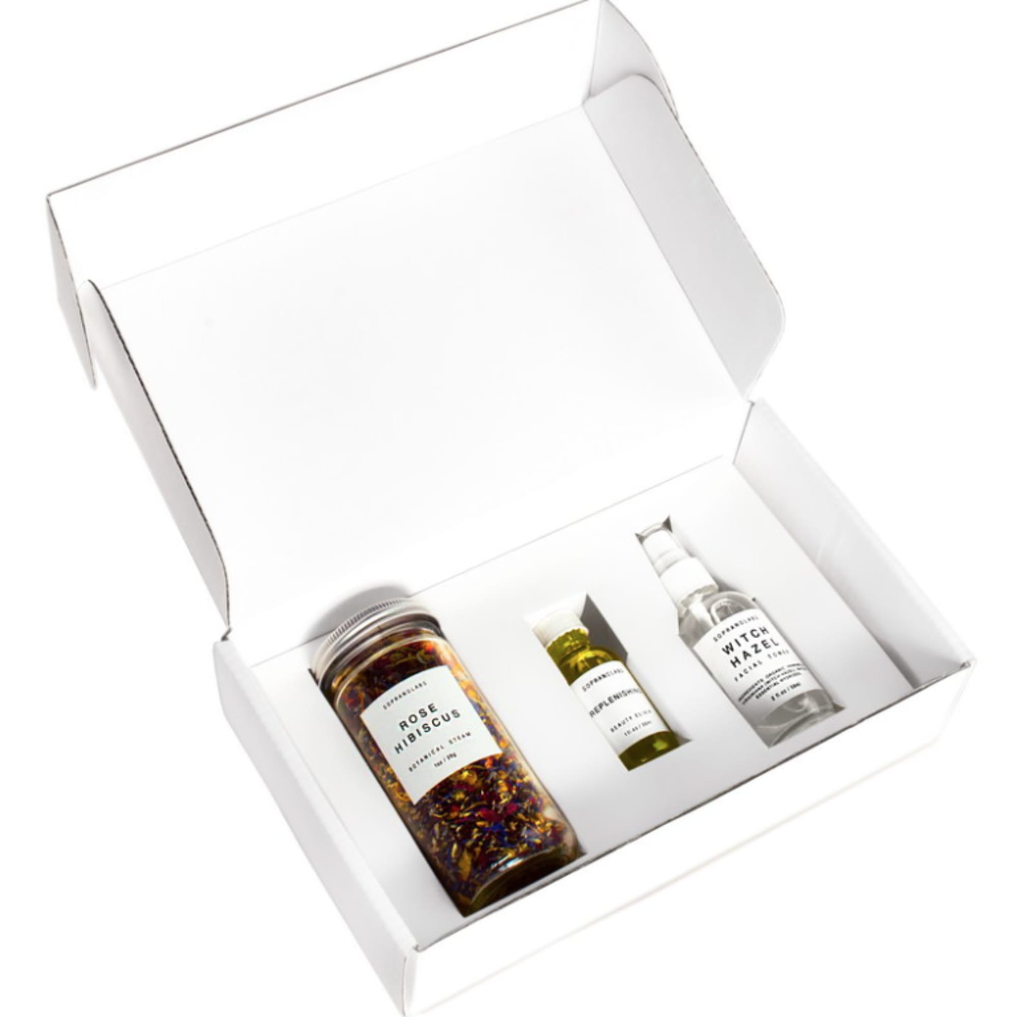 Gift box with three skincare bottles and a jar inside