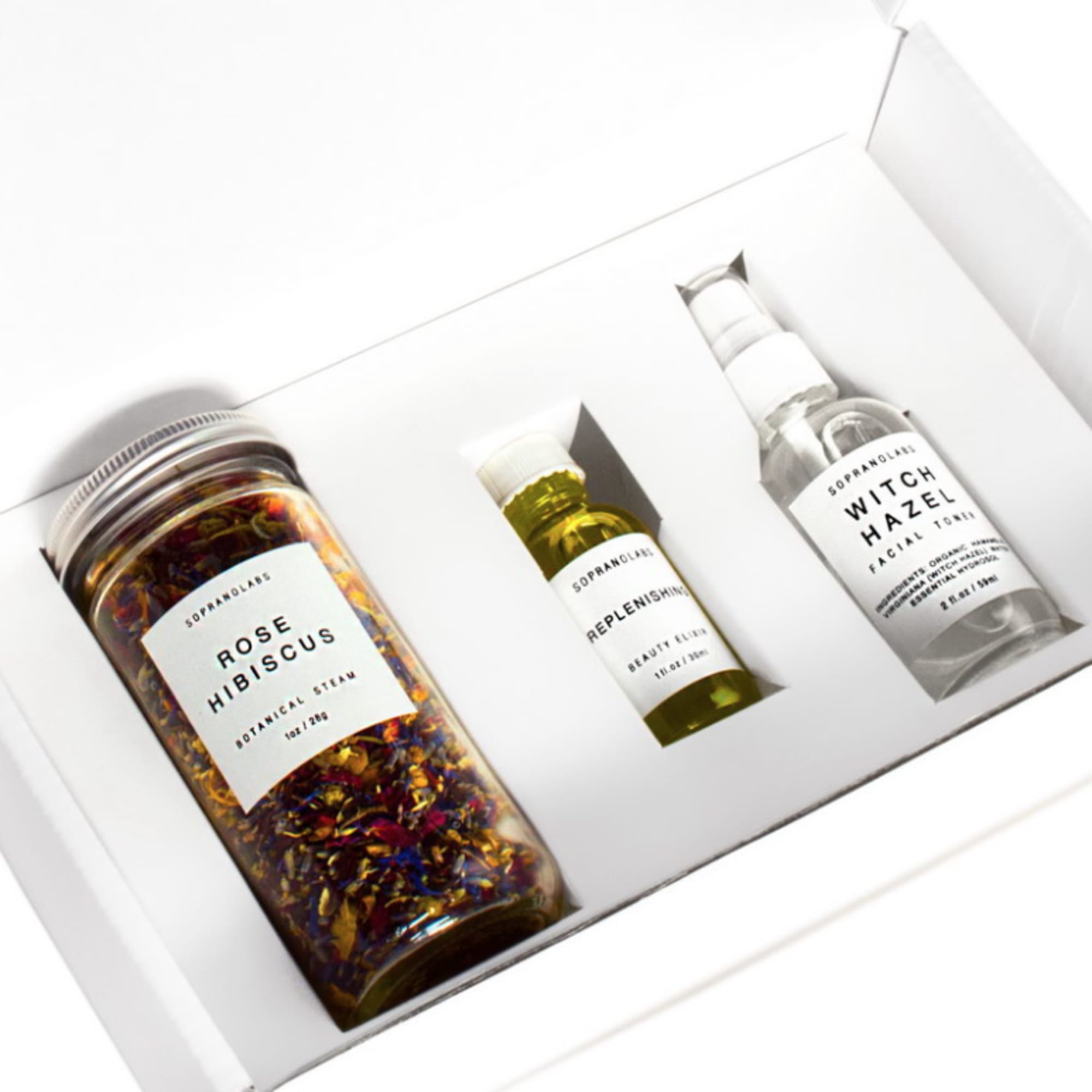 Gift box with three skincare bottles, including rose hibiscus steam