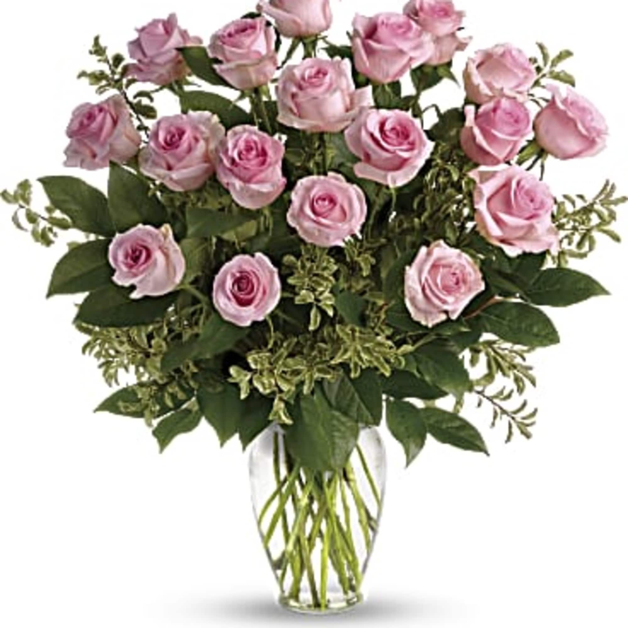 Pink roses arranged in a clear glass vase