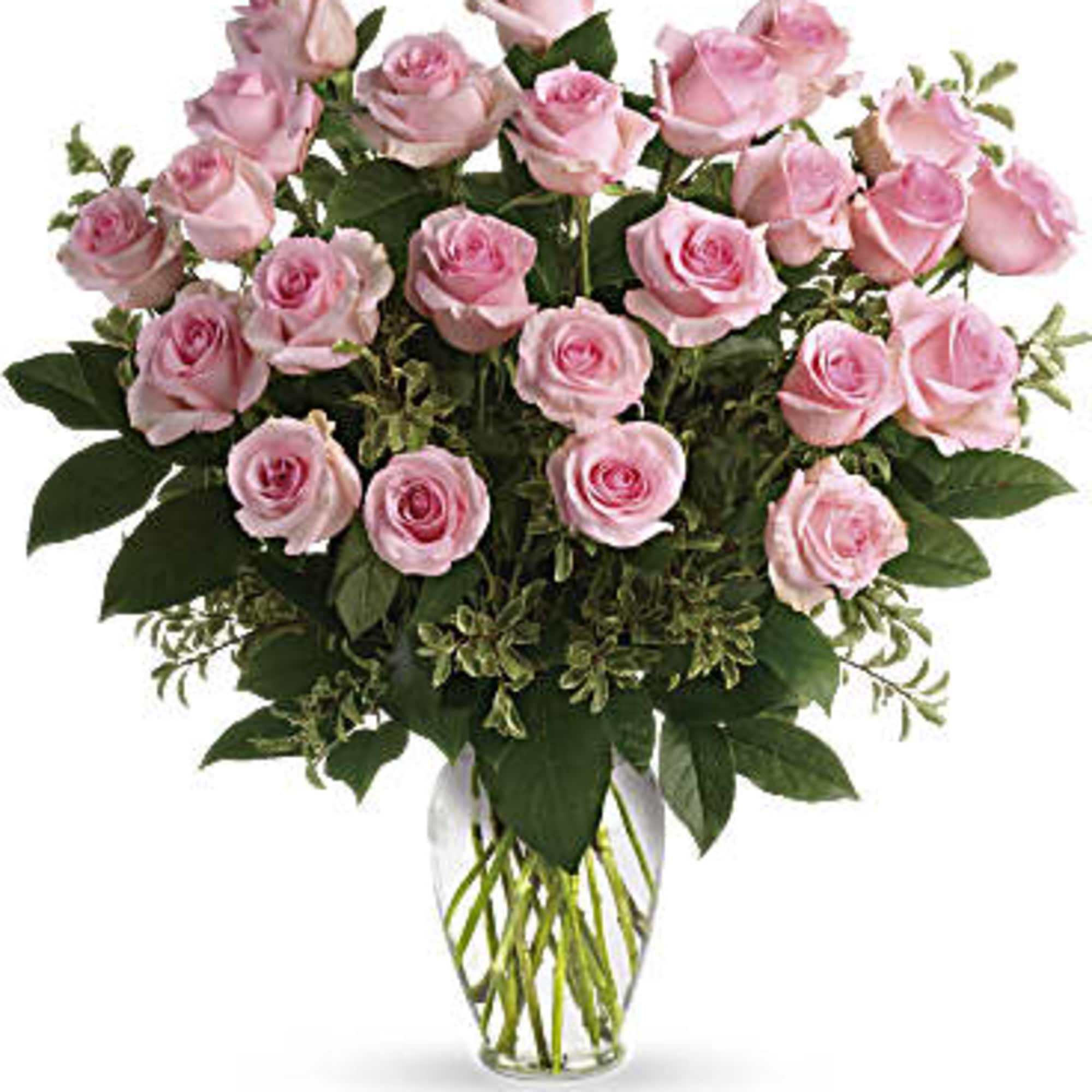 Pink roses arranged in a clear glass vase