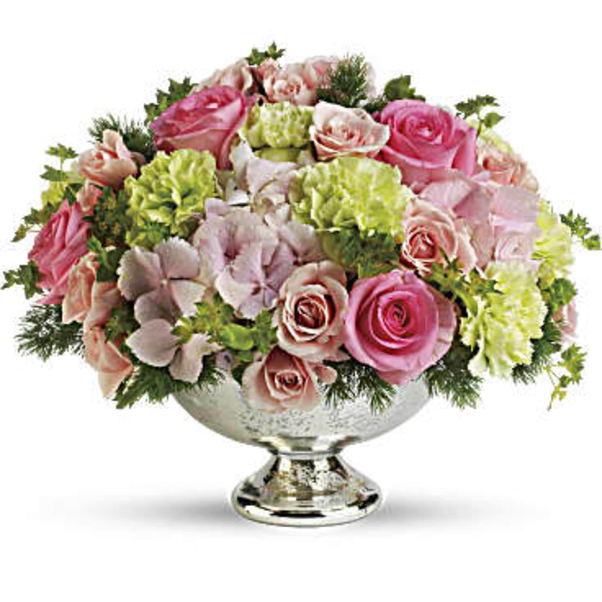 Pink and peach roses with green carnations in a silver pedestal bowl